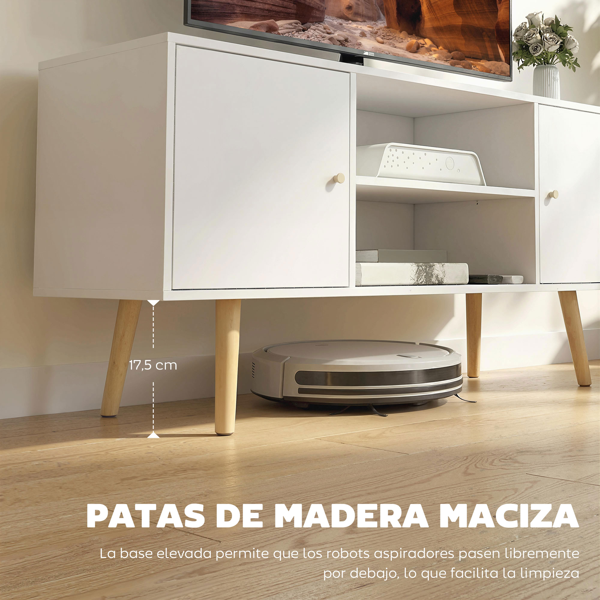Consola blanca con patas de madera, robot aspirador debajo, y flores.