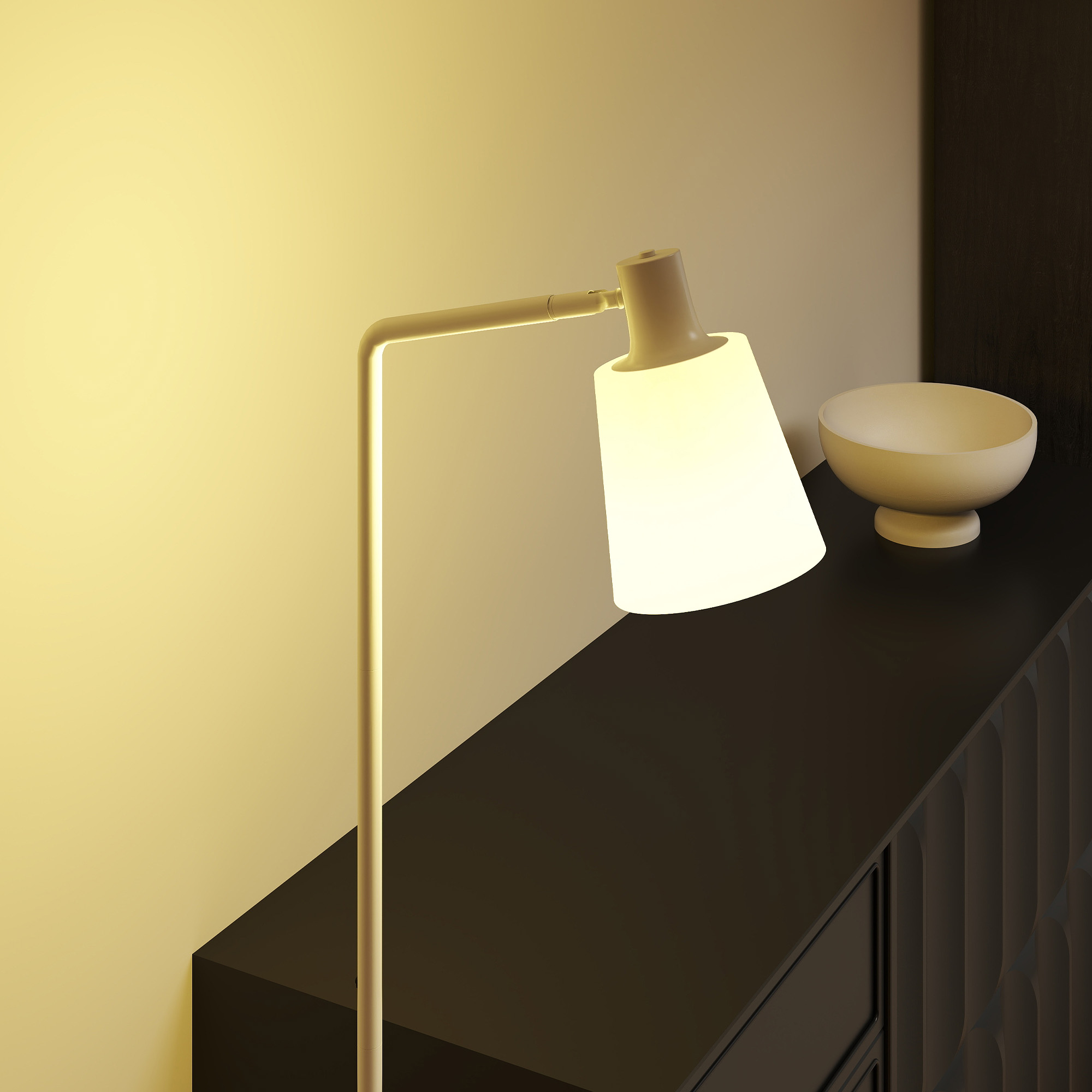 Una lámpara blanca ilumina un mueble oscuro. Un cuenco a su lado.