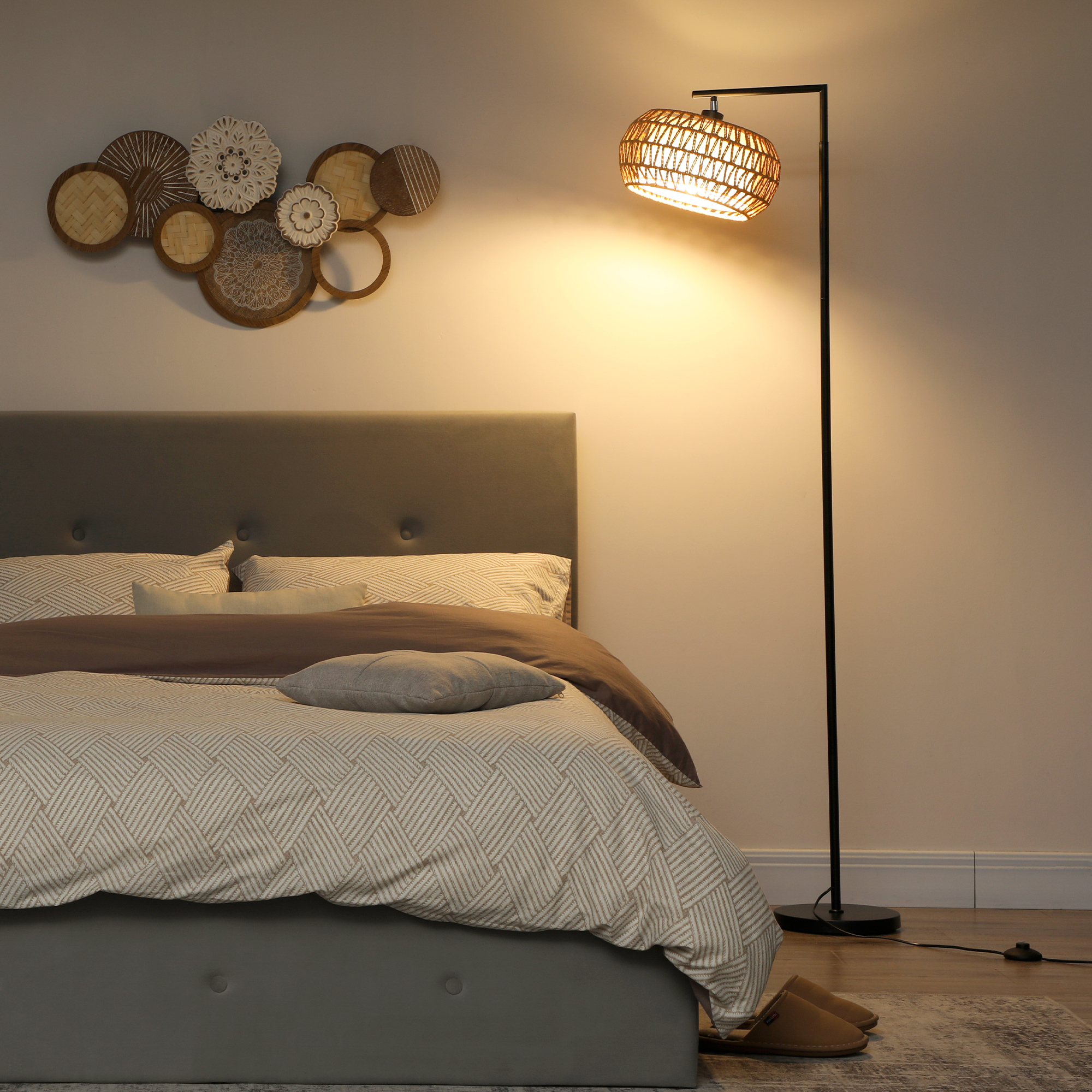 Un dormitorio con cama, decoración de pared y lámpara de pie.