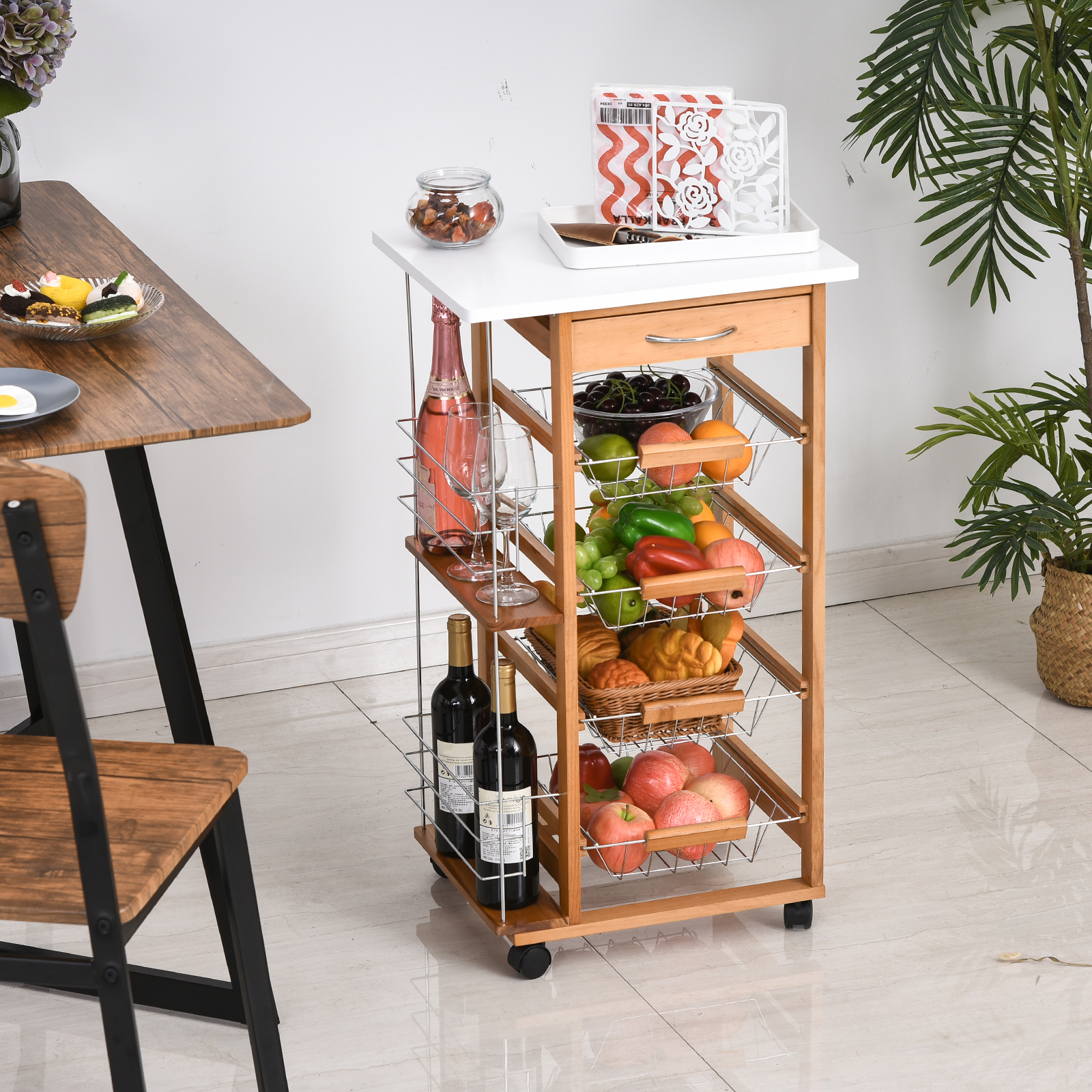 Un carrito de servicio de madera con frutas, botellas y vasos.