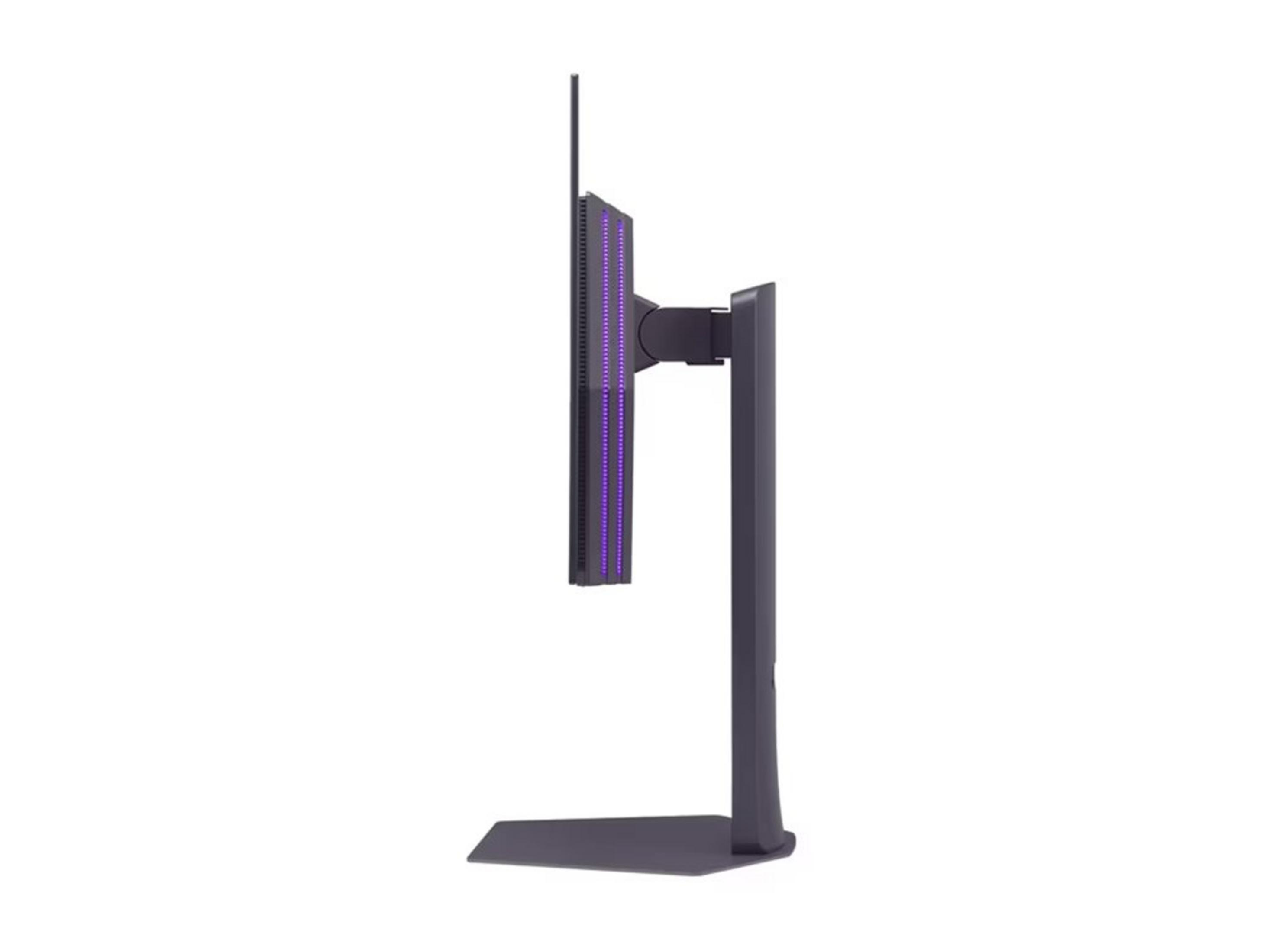 A dark computer monitor with purple lights on its side, on a stand.