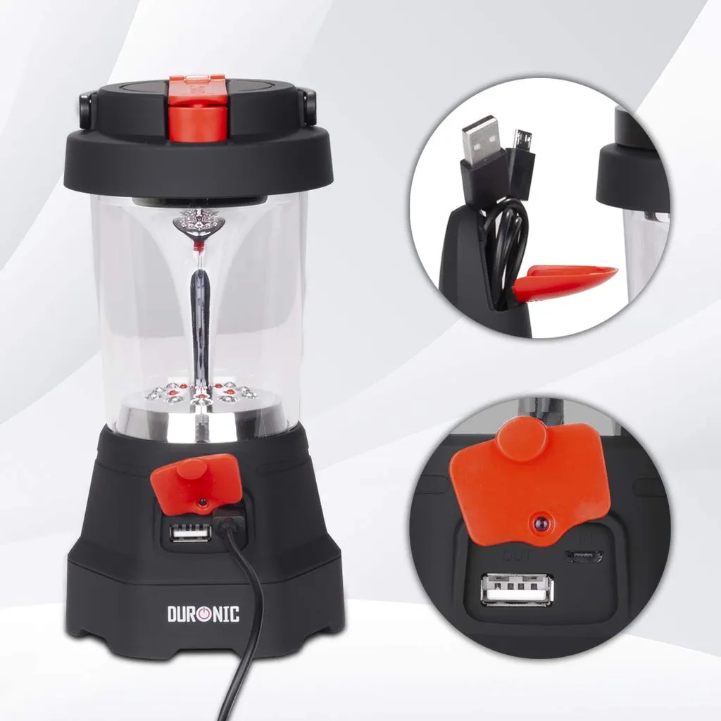 Schwarze Laterne mit rotem Knopf, transparentem Gehäuse und USB-Anschlüssen.