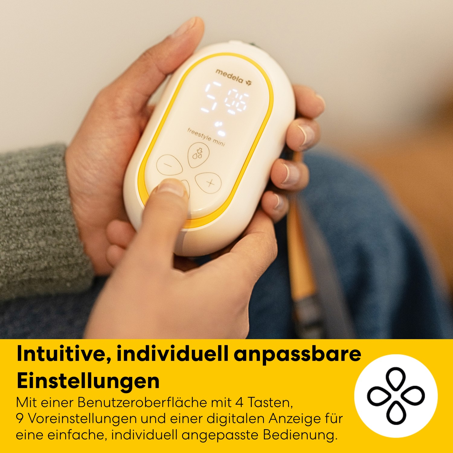 Person bedient Medela Freestyle Mini Pumpe mit digitaler Anzeige und Tasten.