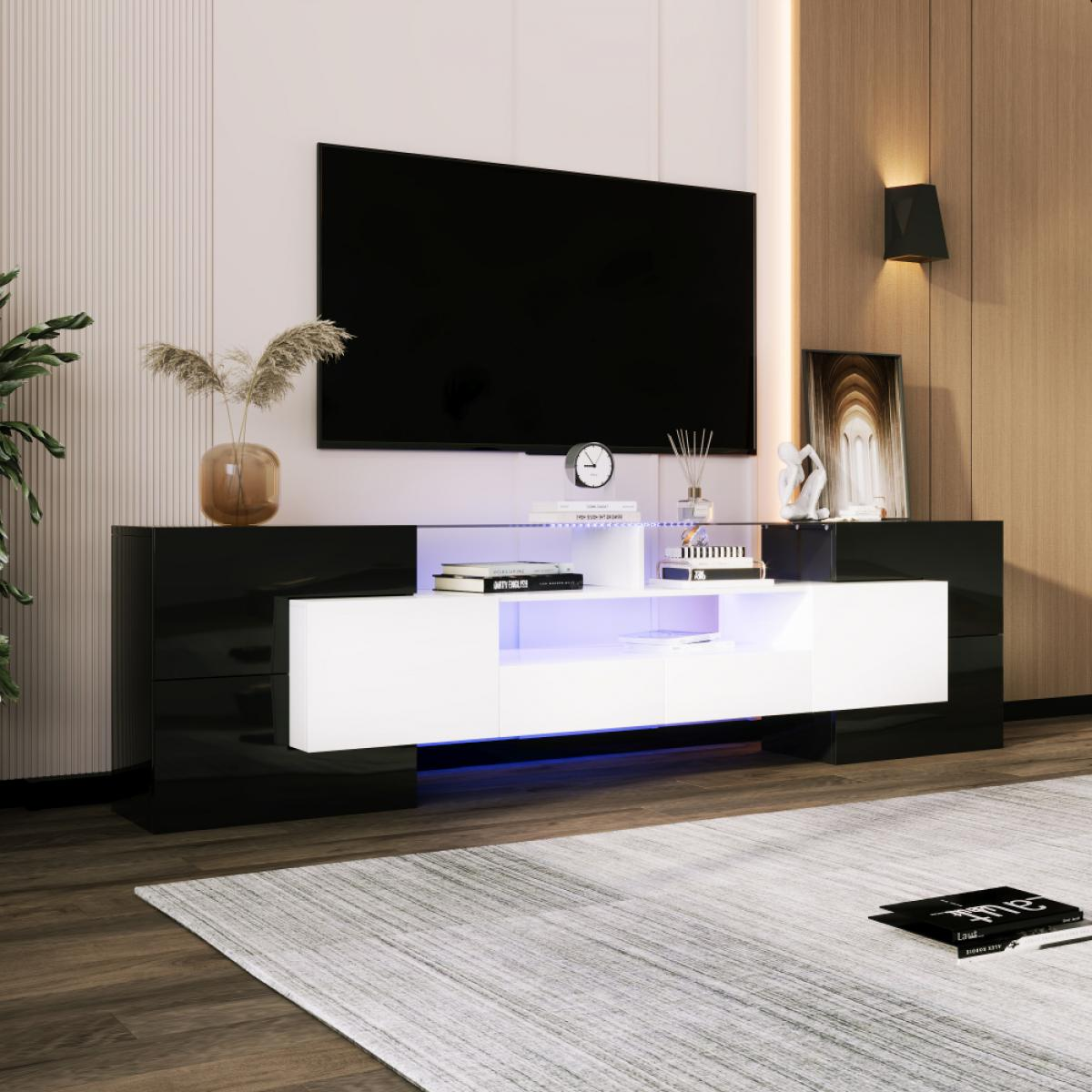 Ein moderner schwarzer und weißer TV-Schrank mit beleuchteten Fächern und einem großen schwarzen Fernsehbildschirm.