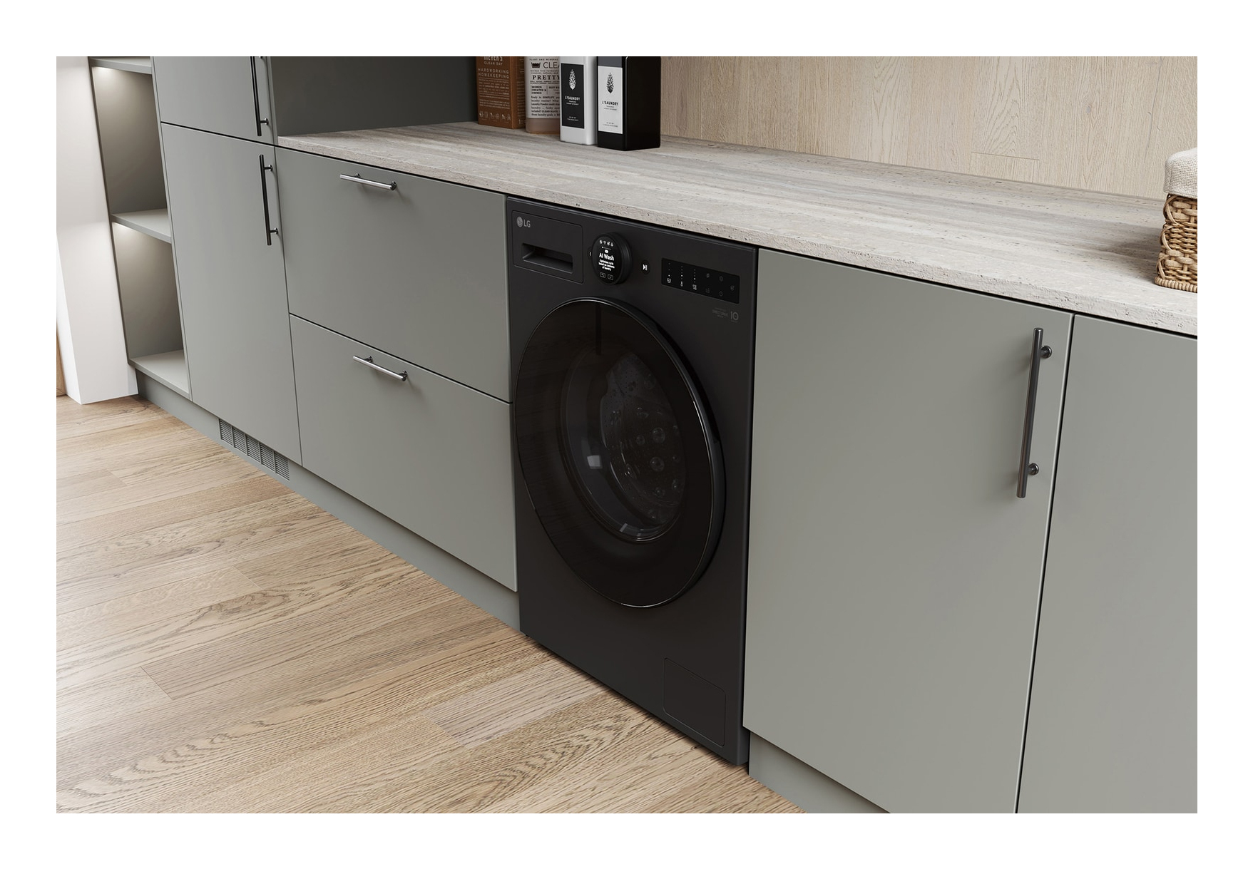 Black washing machine in a kitchen with grey cabinets and wooden floor.