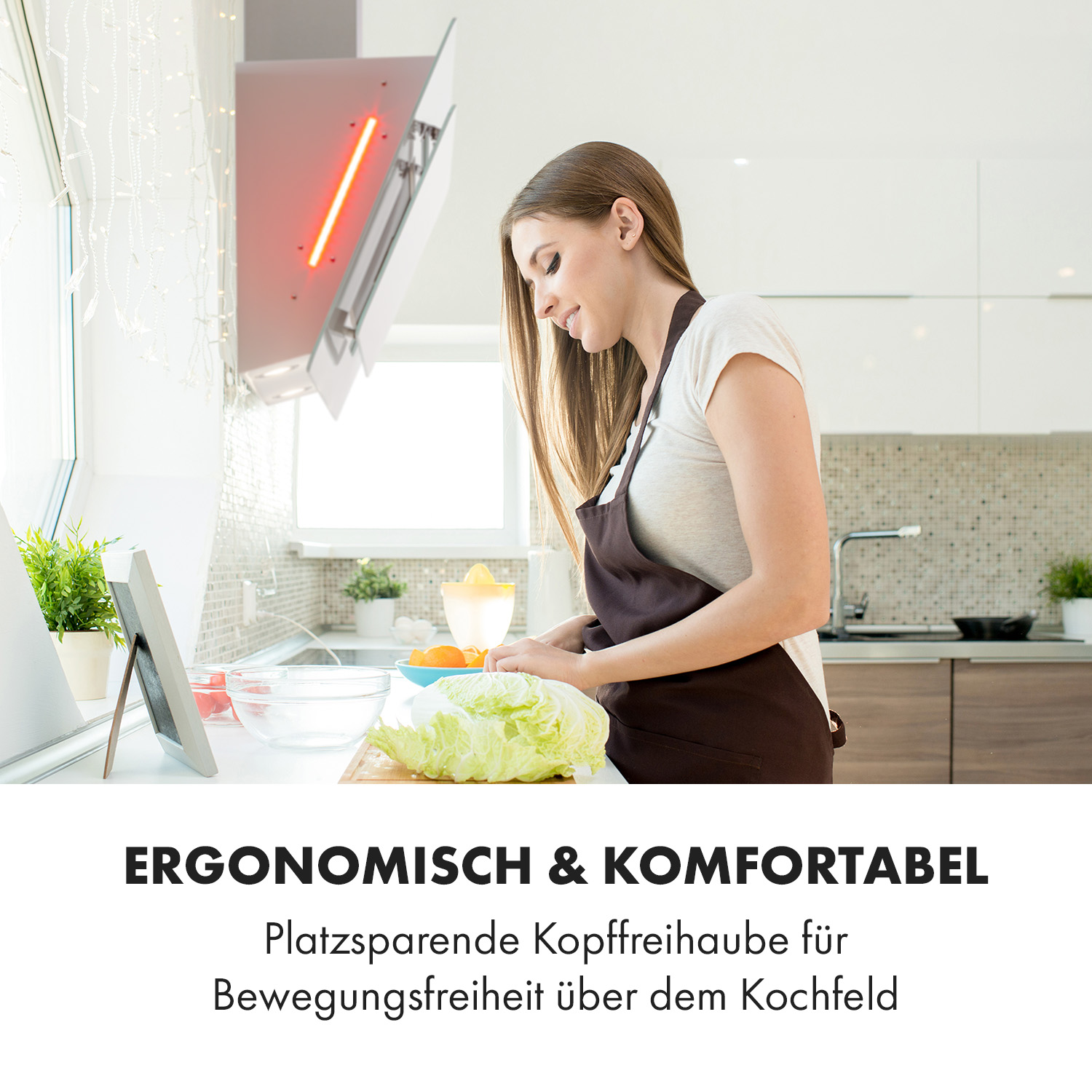 Una donna in cucina prepara l'insalata. Cappa aspirante si illumina di rosso.