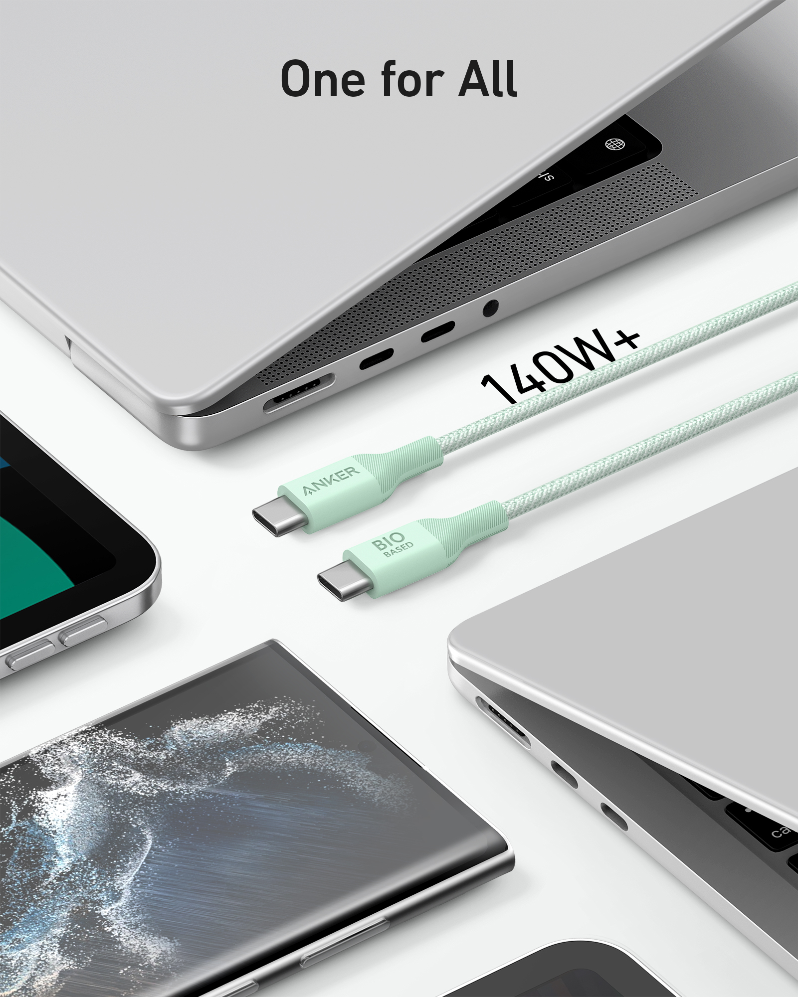 Un cavo USB-C verde menta da 140W+ poggia vicino a laptop e smartphone.