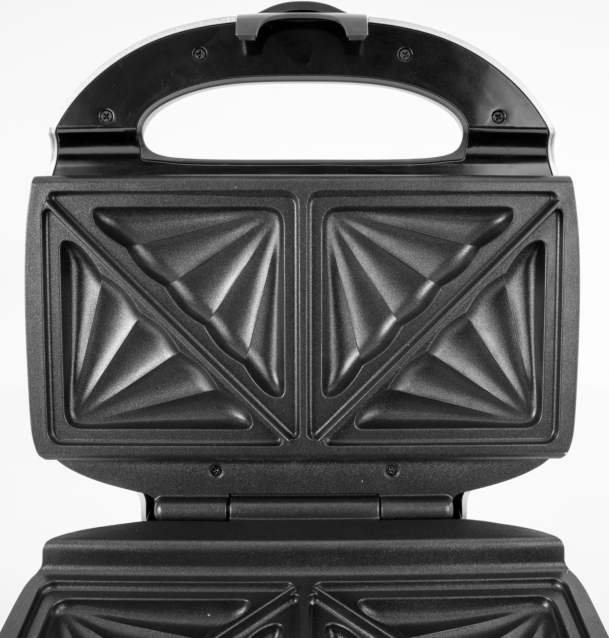 Otwarty opiekacz do kanapek z czarnymi płytami grzewczymi i uchwytem.