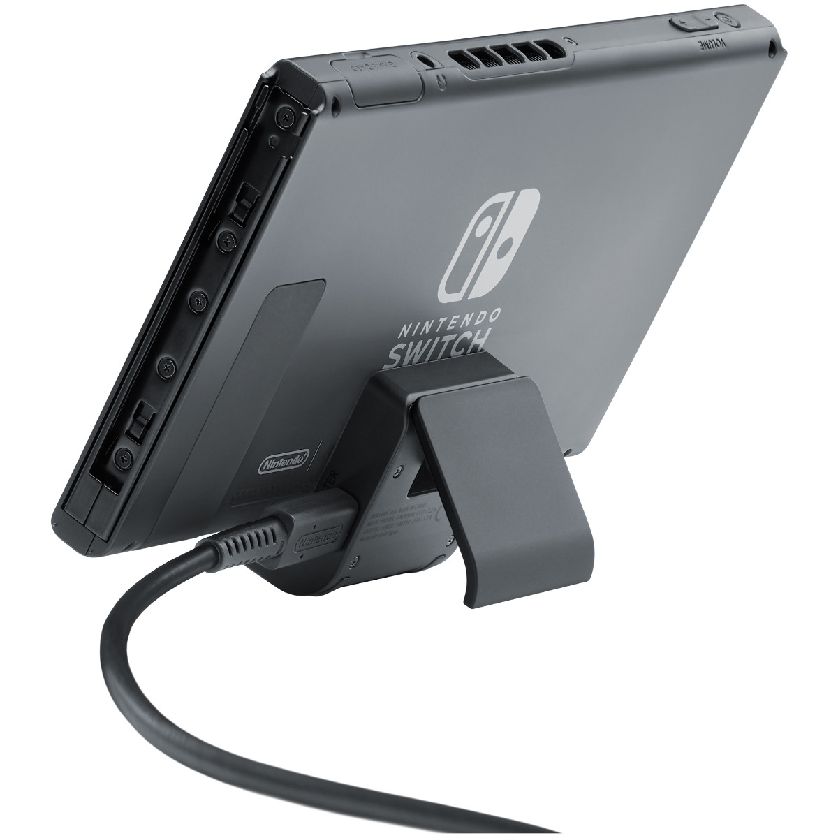 Graues Nintendo Switch mit Ständer und angeschlossenem Kabel.