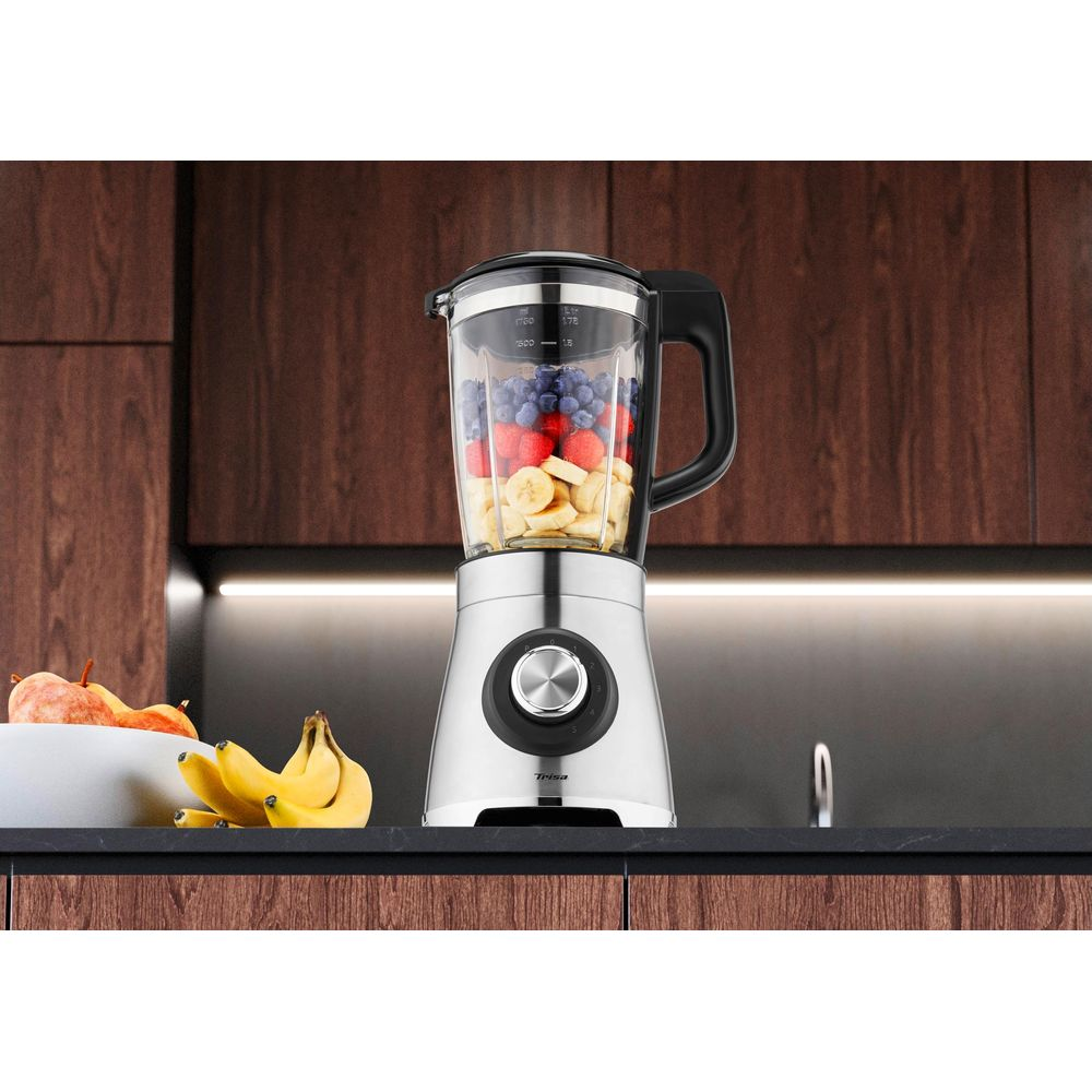 Ein silberner Mixer mit Beeren, Erdbeeren und Bananen, bereit zur Zubereitung.