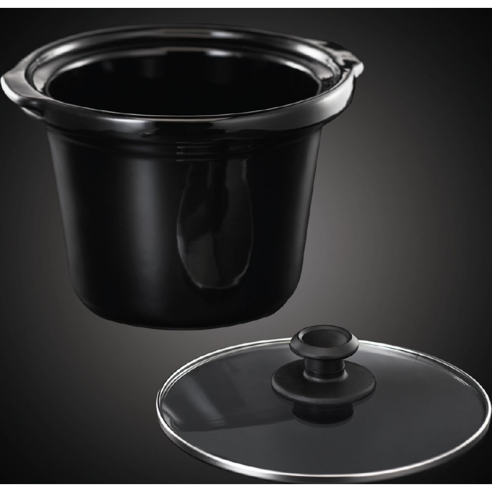 Schwarzer Keramikeinsatz einer Kochplatte mit Glasdeckel daneben.