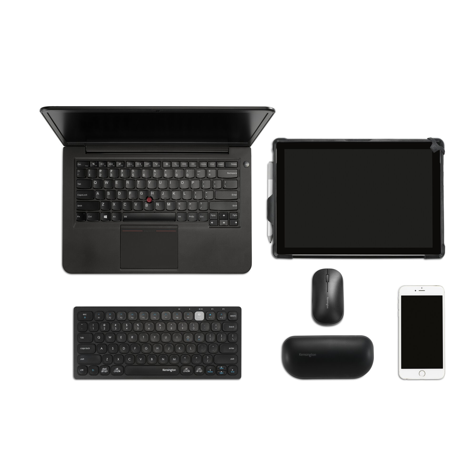 Un ordinateur portable, une tablette, une souris, un téléphone et deux claviers blancs.