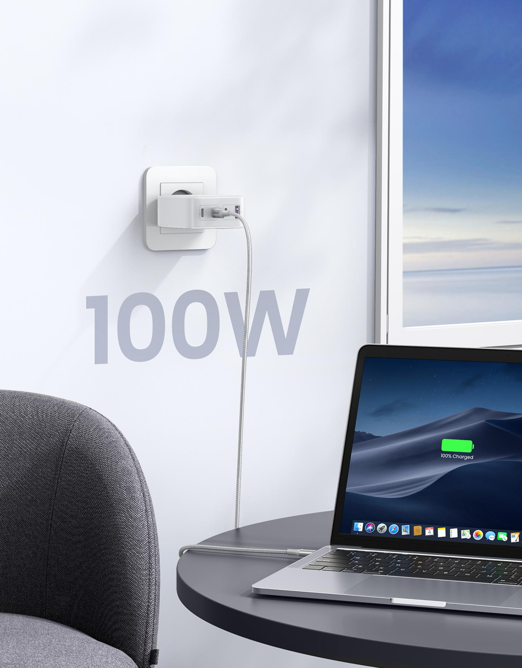 Laptop jest zasilany białym adapterem podłączonym do gniazdka ściennego.