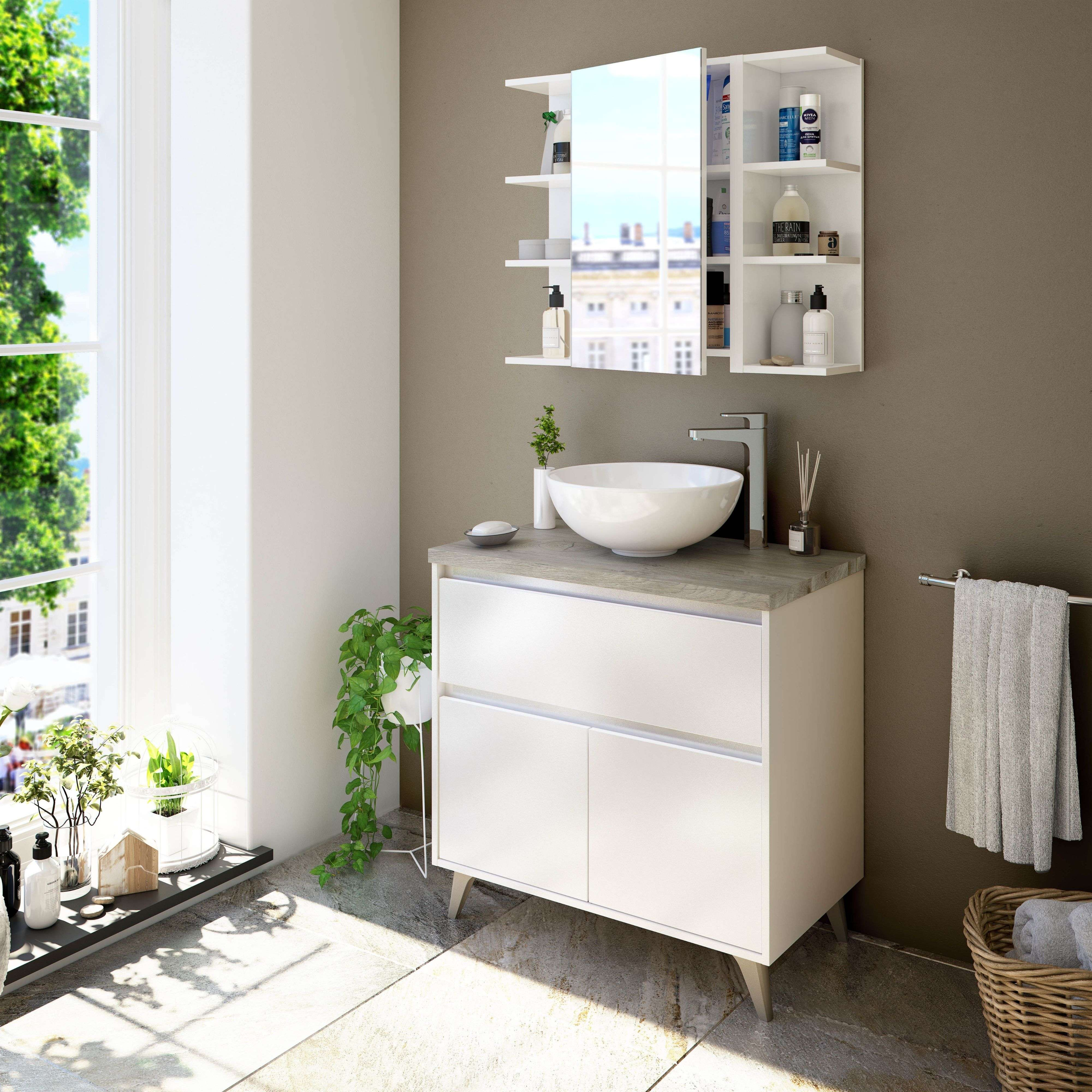 Un baño moderno con mueble de lavabo blanco, lavabo y botiquín con espejo.