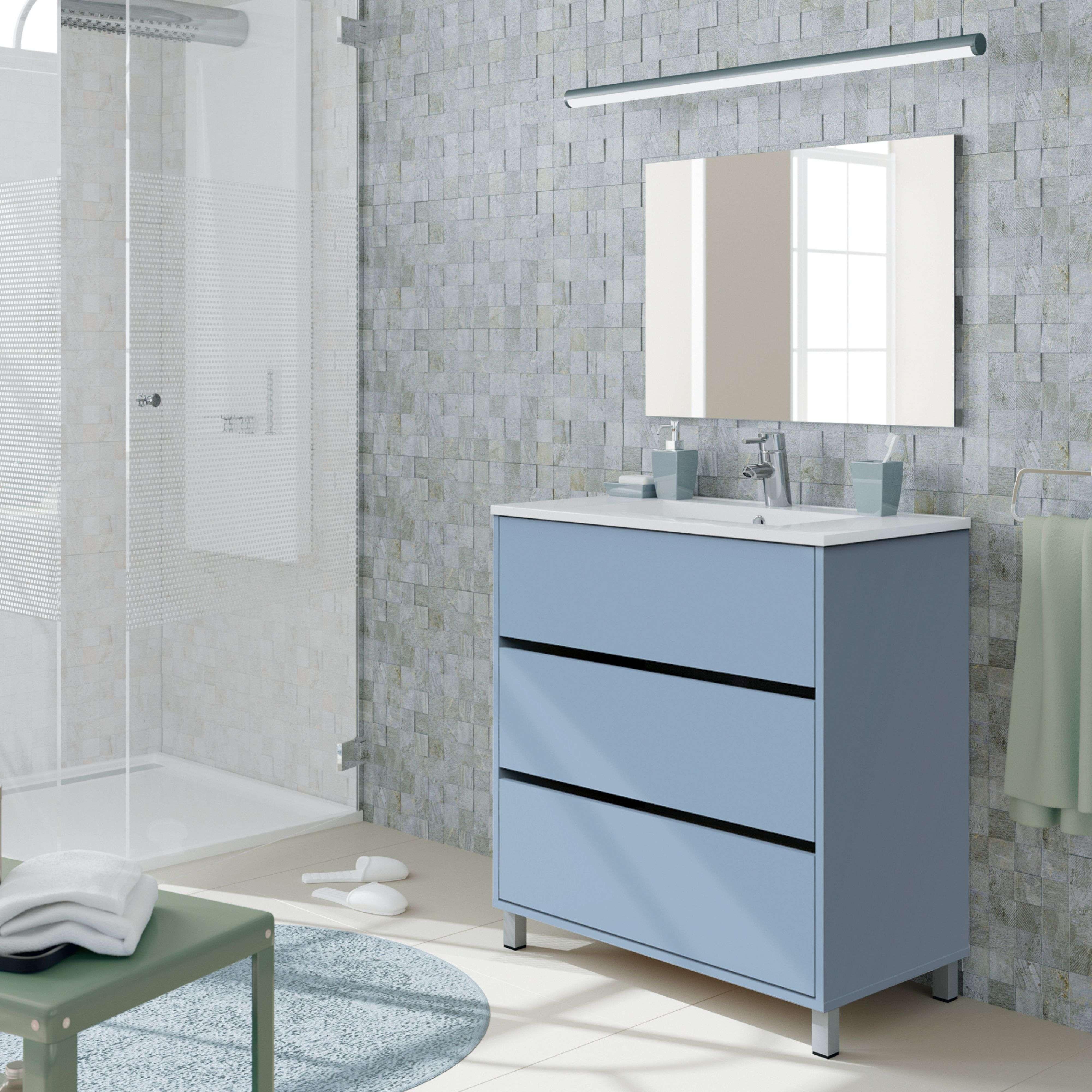 Baño moderno con mueble de lavabo azul, ducha y espejo.