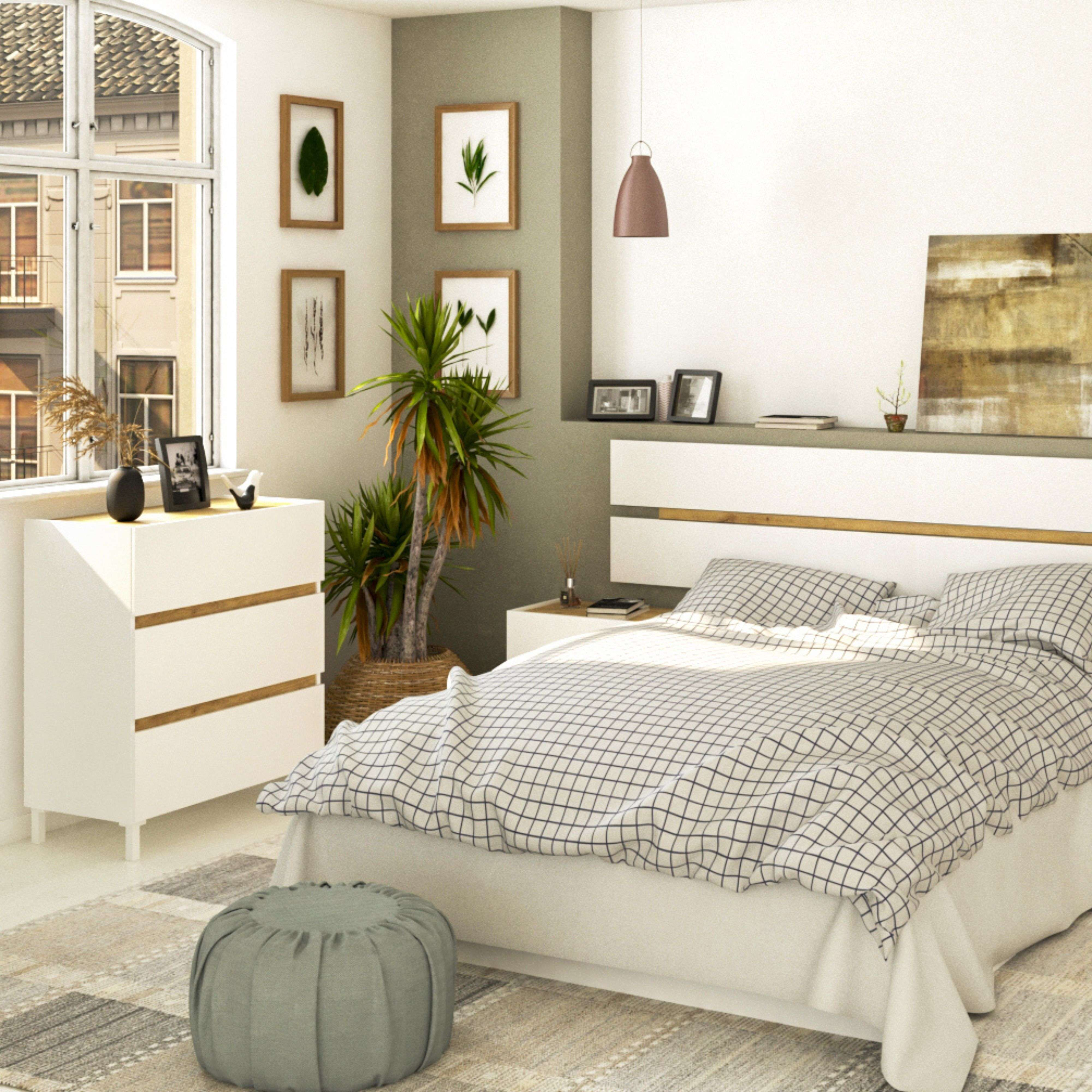 Un dormitorio con cama, cómoda, ventana y plantas.