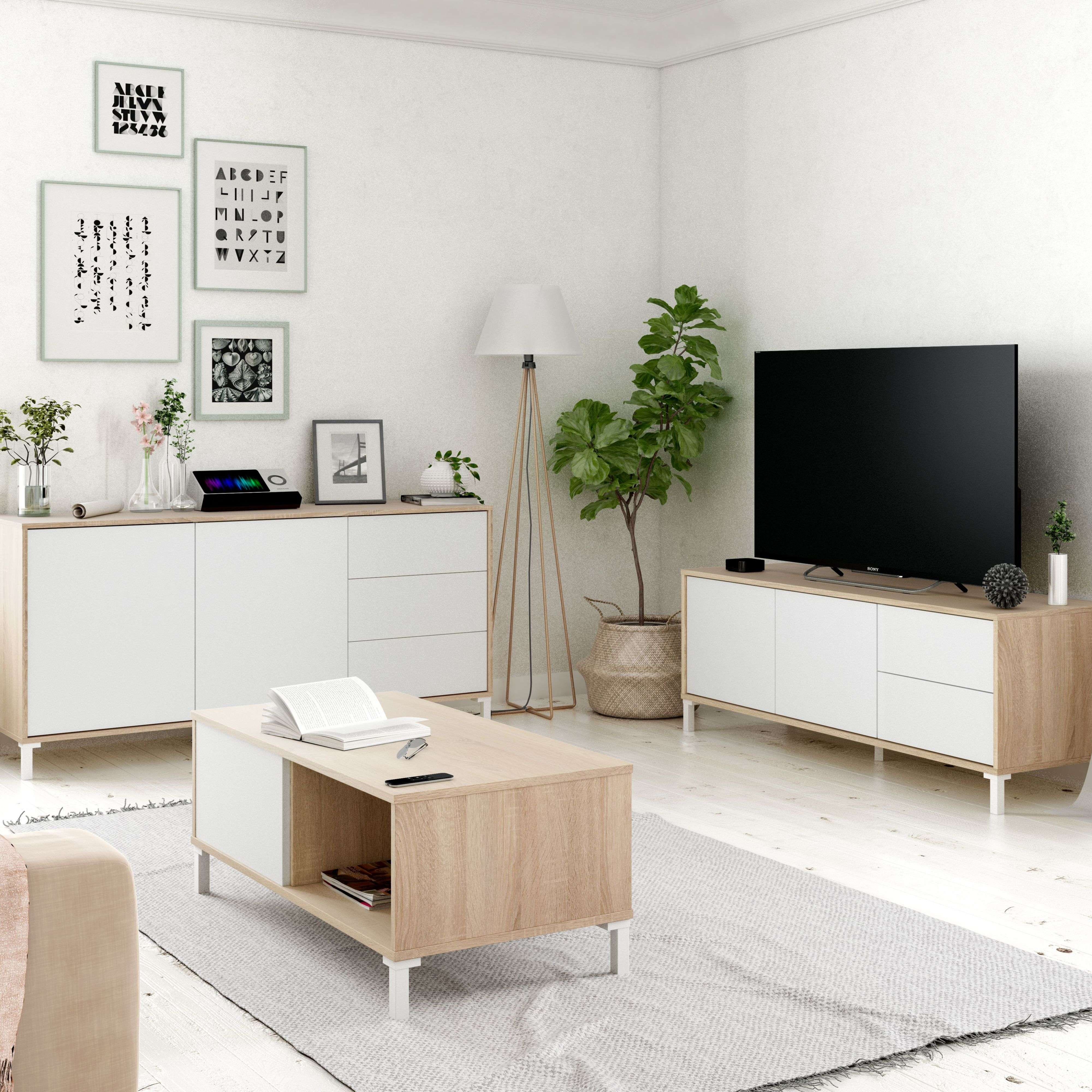Sala de estar moderna con muebles blancos y de madera, TV y plantas.