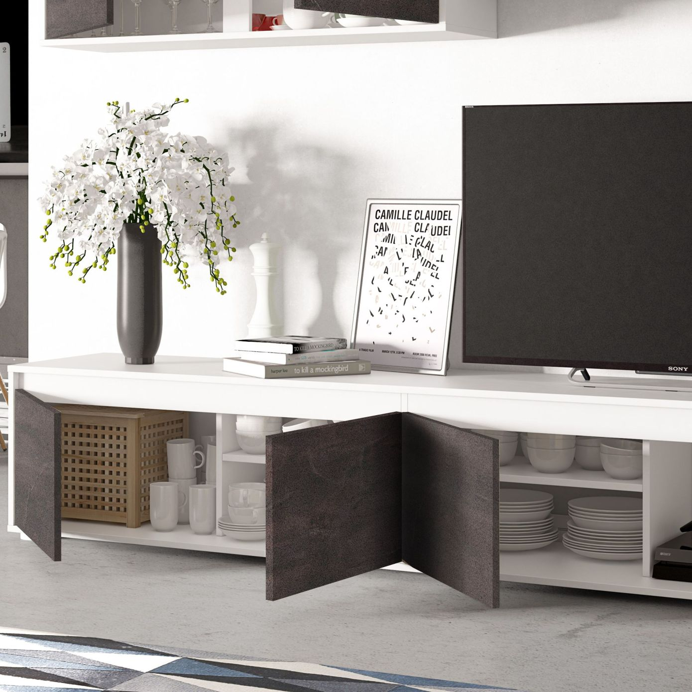Un mueble blanco con compartimento abierto, vajilla, libros, jarrón con flores y TV.