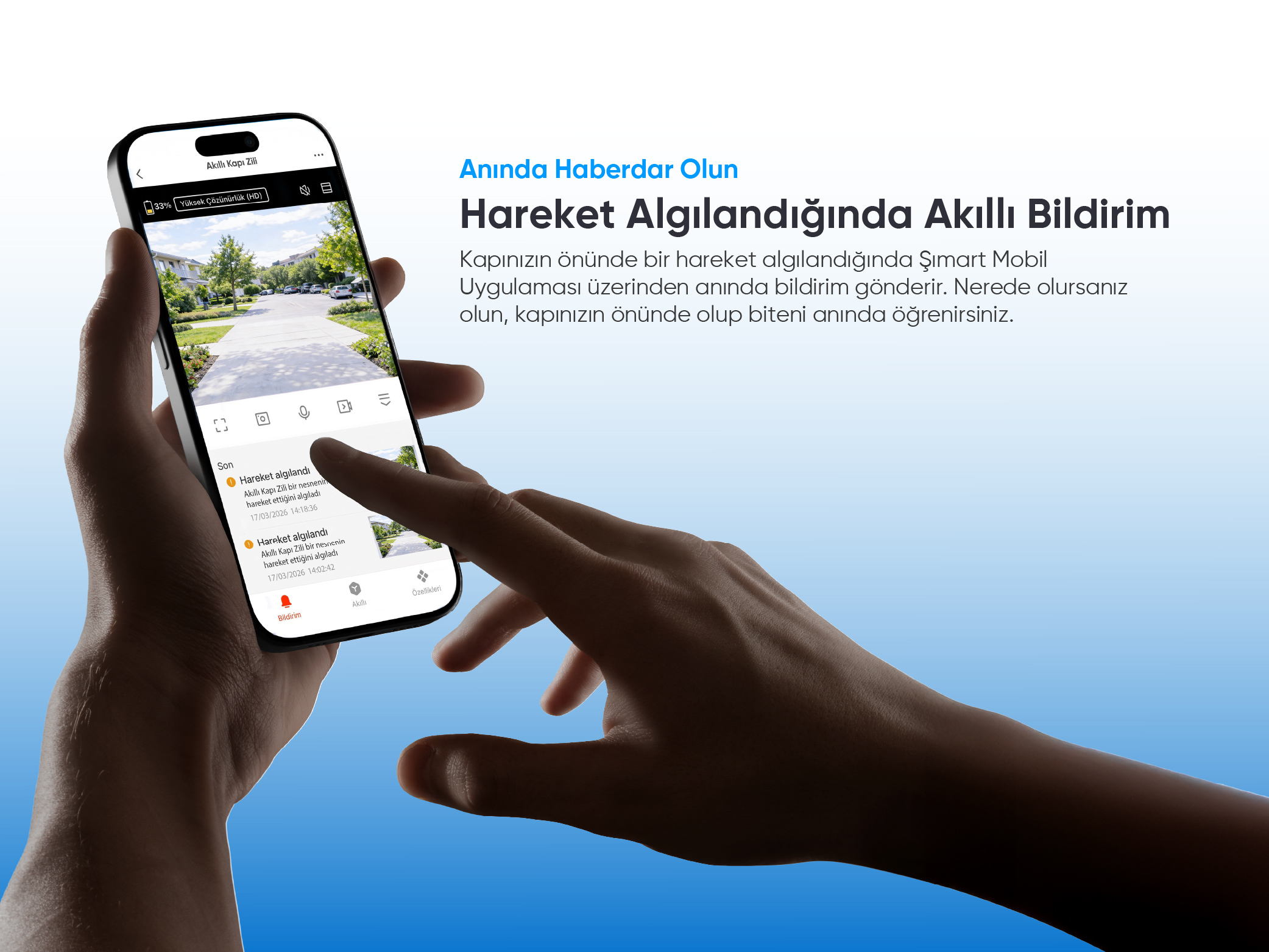 Akıllı telefon, sokak manzaralı bir hareket algılama bildirimi gösteriyor.