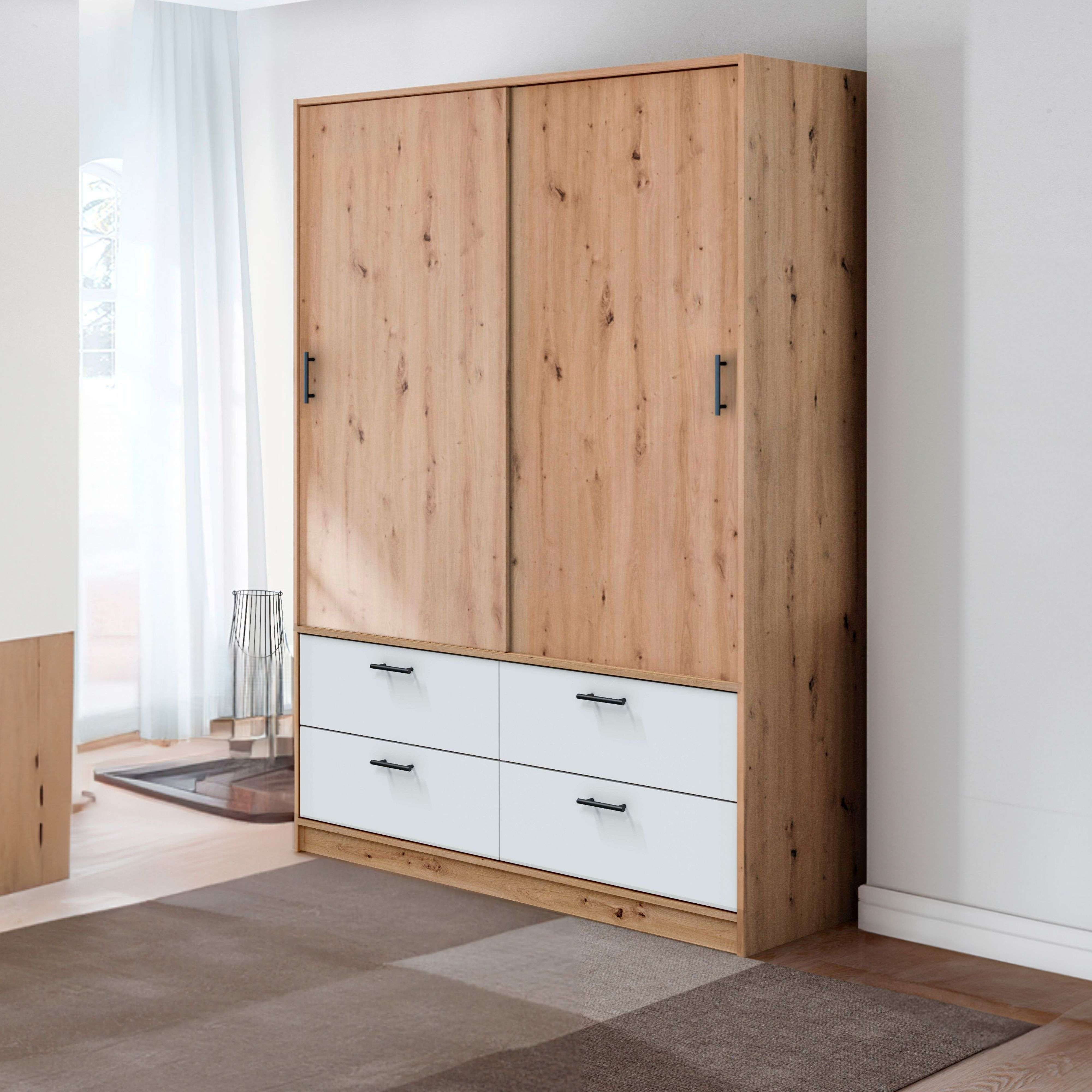 Un armario de madera con cajones blancos y tiradores negros.