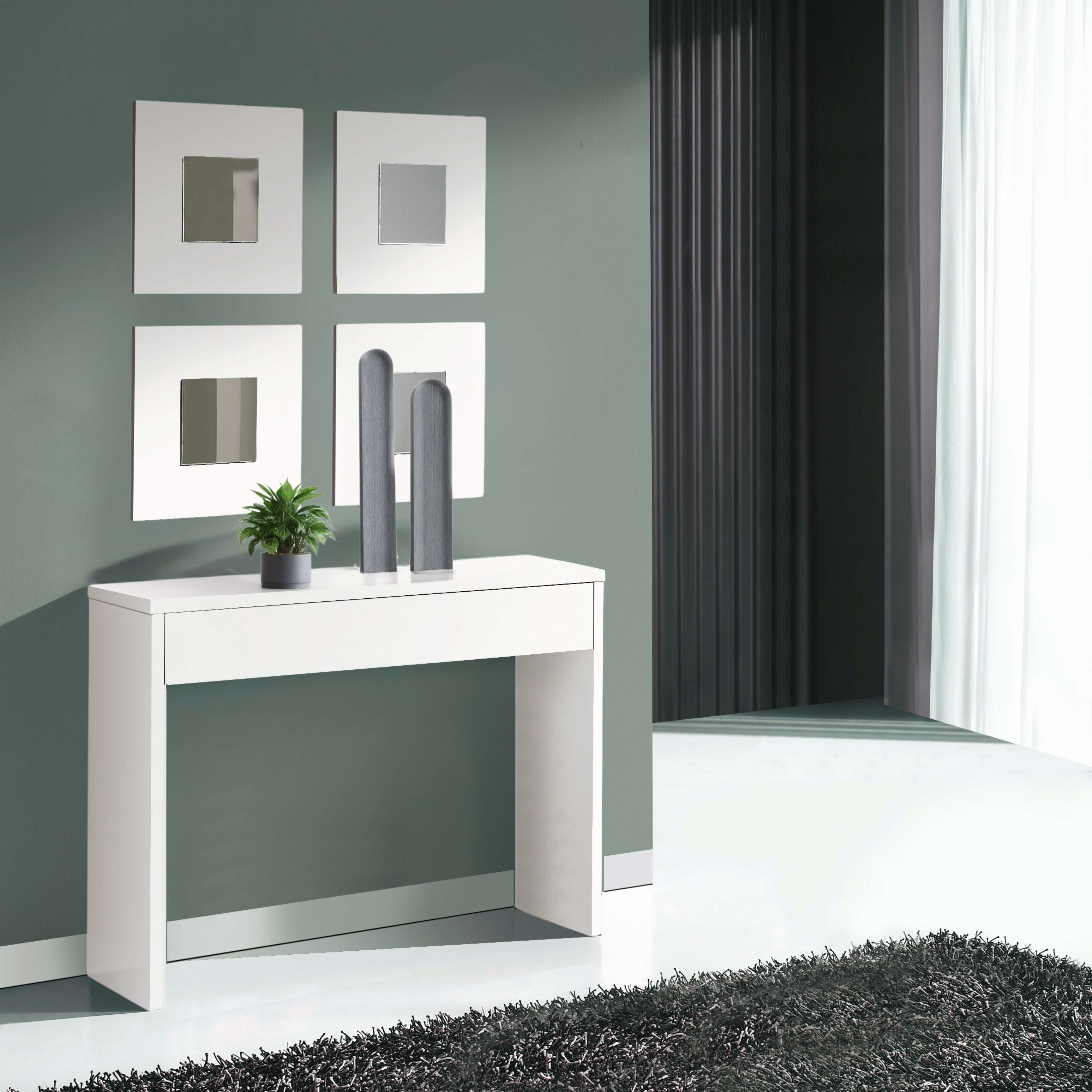 Una mesa consola blanca con decoración y planta contra pared verde.