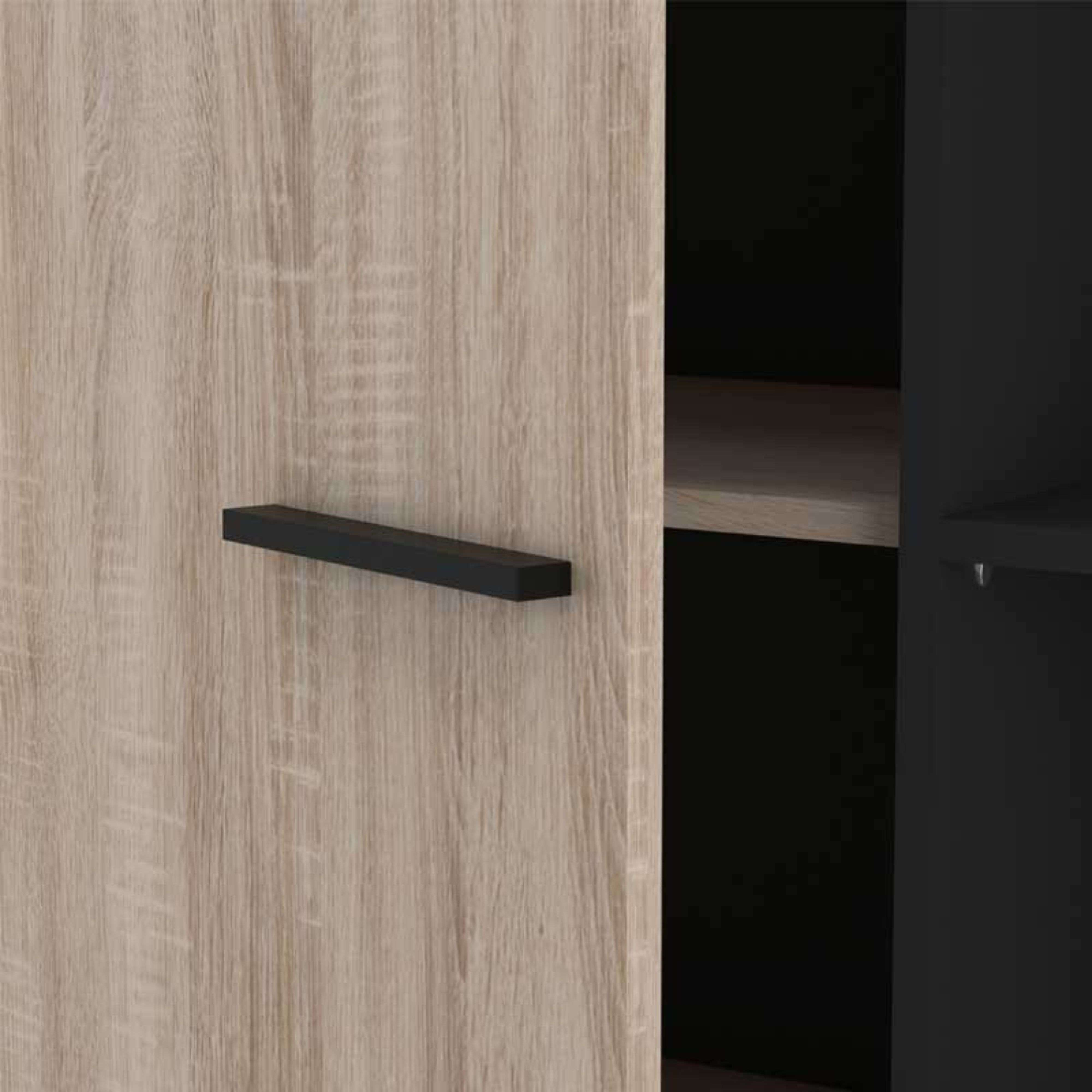 Puerta de armario de madera con tirador negro y estante negro detrás.