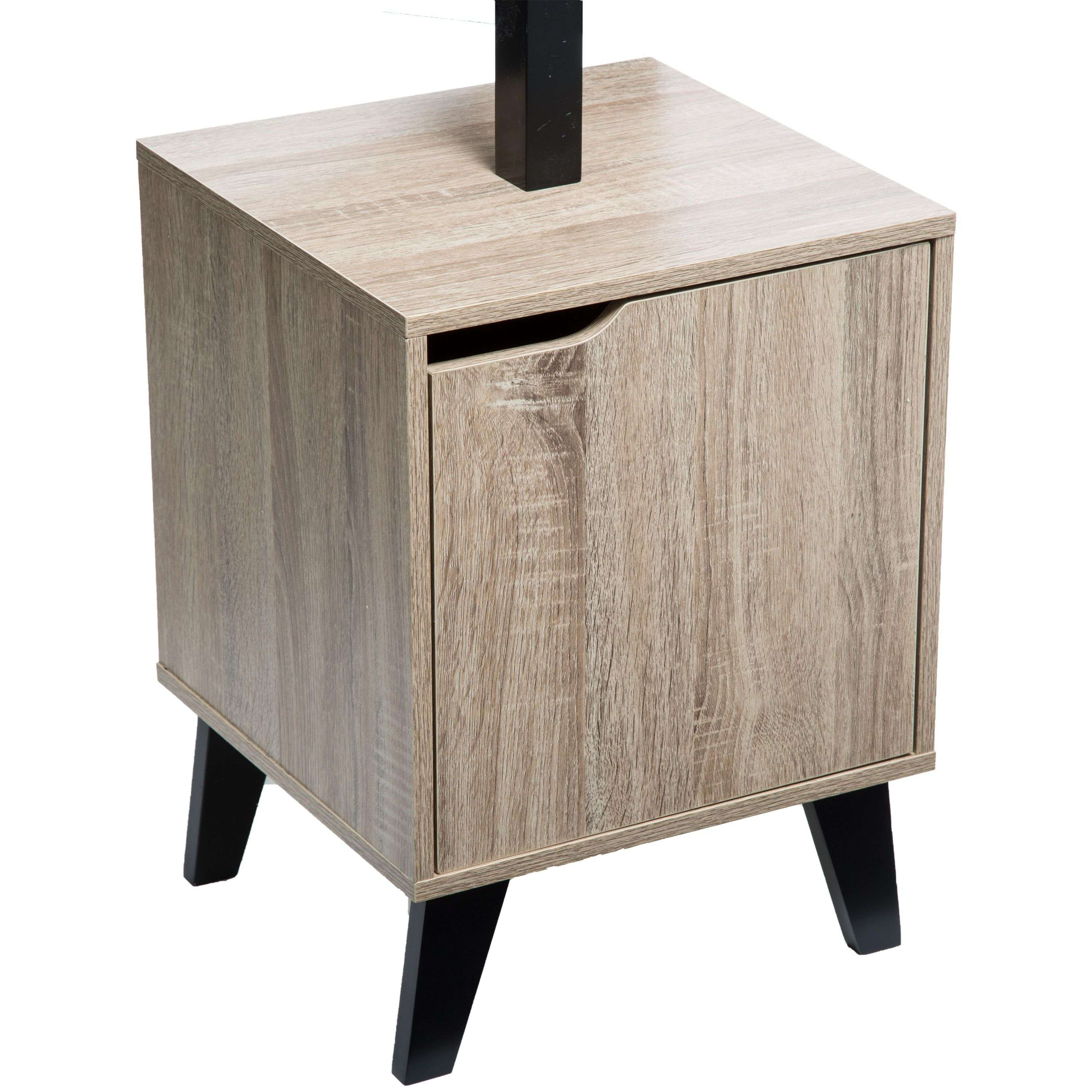 Una mesita de noche pequeña de imitación madera clara con una puerta y patas negras.