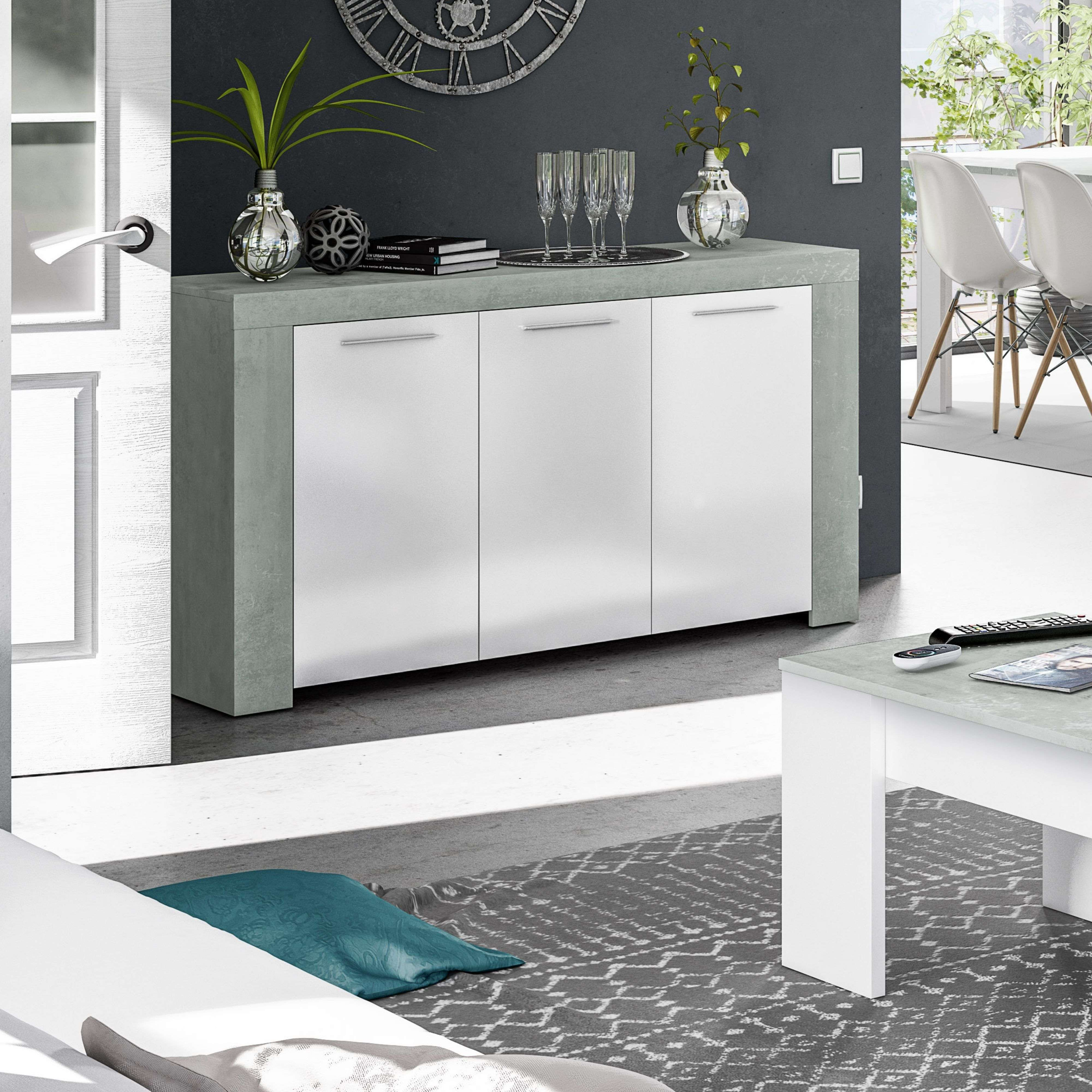 Un aparador moderno de salón con aspecto de hormigón y puertas blancas.