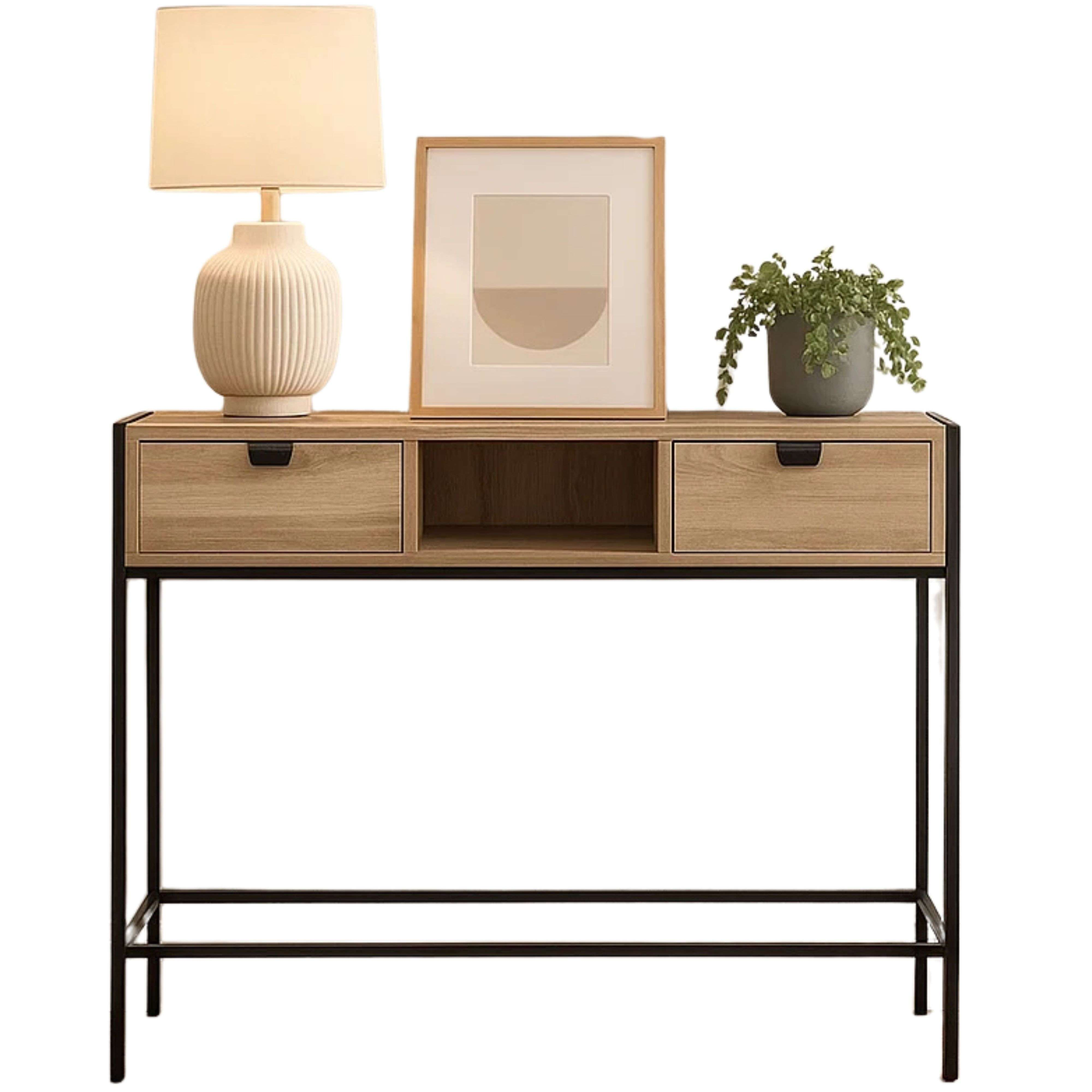 Lámpara blanca, cuadro enmarcado y planta sobre mesa consola de madera con patas negras.