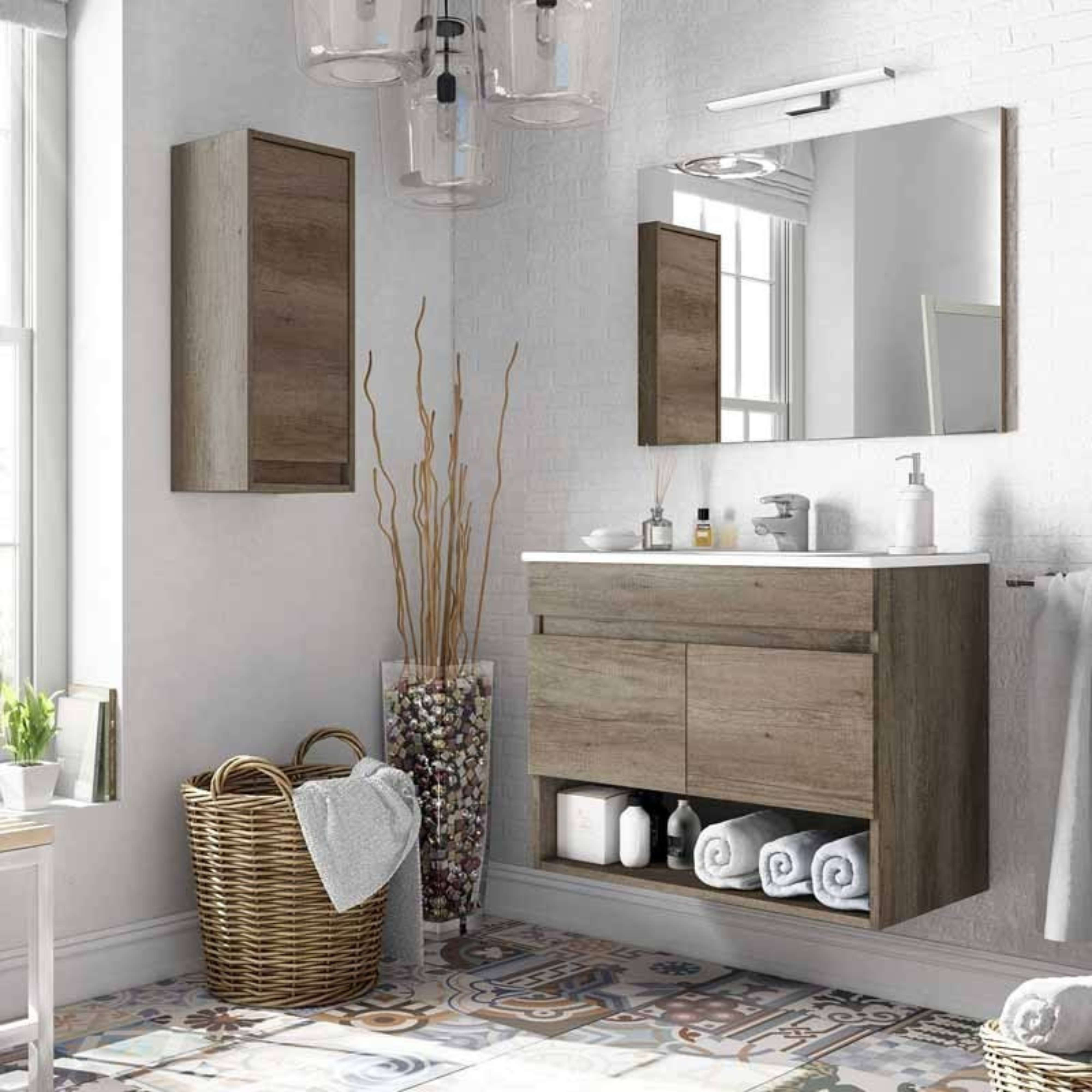 Un baño con muebles de madera, espejo, lavabo y cesta.