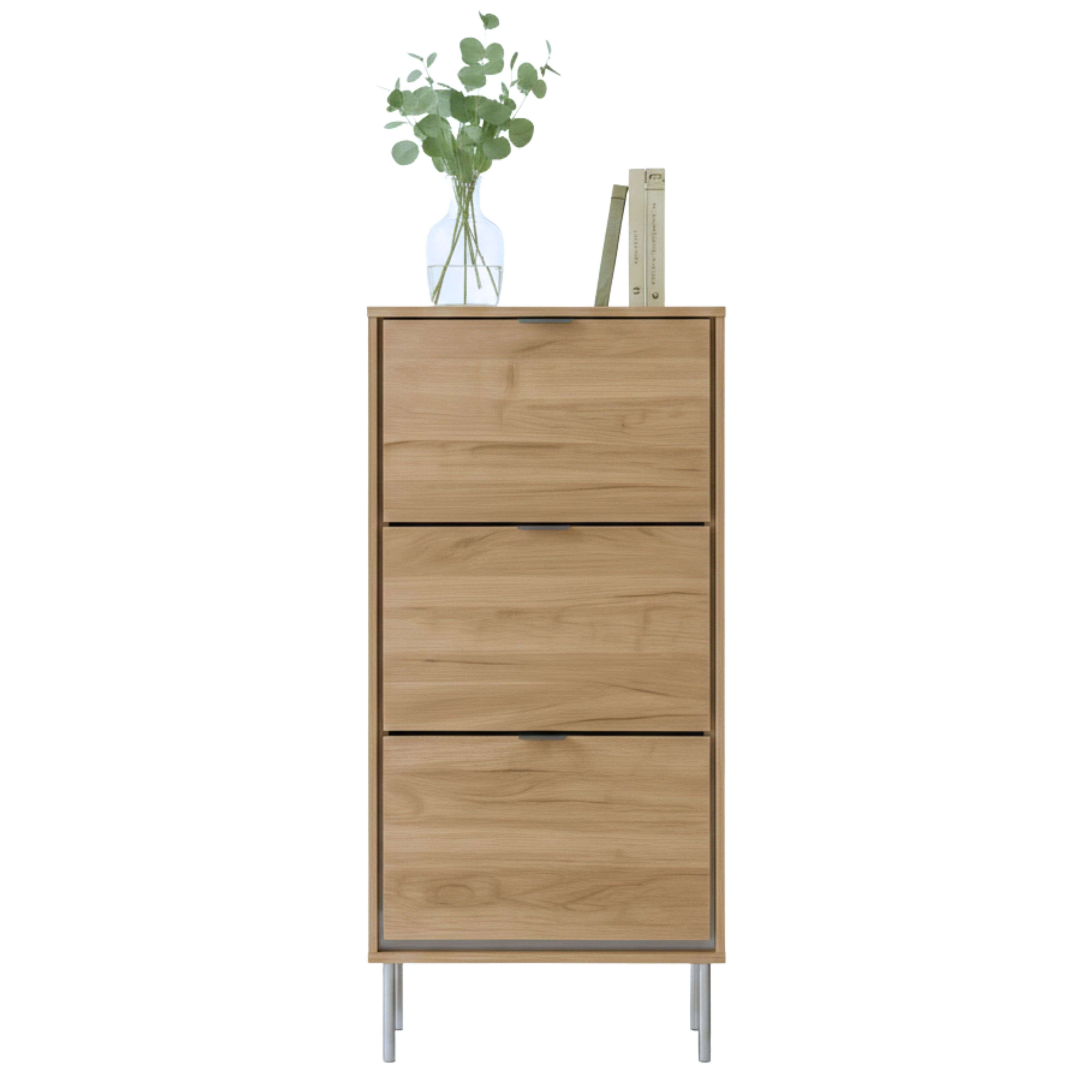Un estrecho mueble de madera con tres cajones y patas plateadas.
