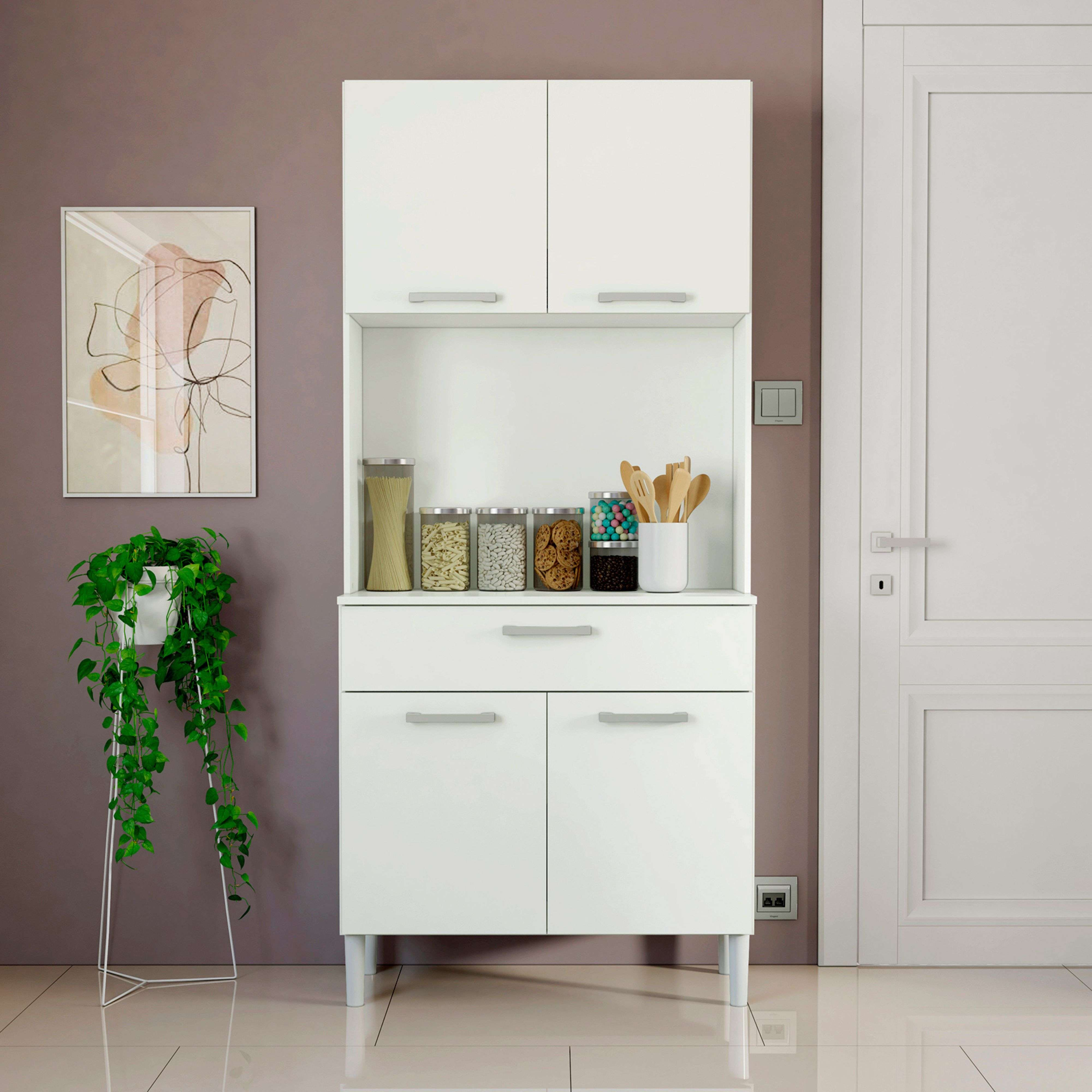 Un aparador de cocina blanco con frascos de vidrio y puertas, junto a una planta y un cuadro.
