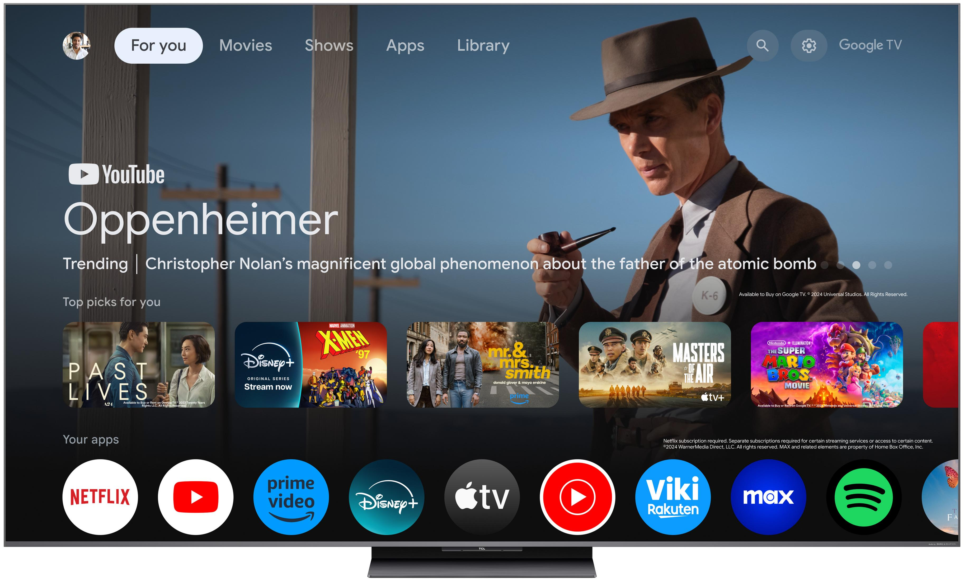 Pantalla de inicio de Google TV con pósteres de películas e iconos de apps.