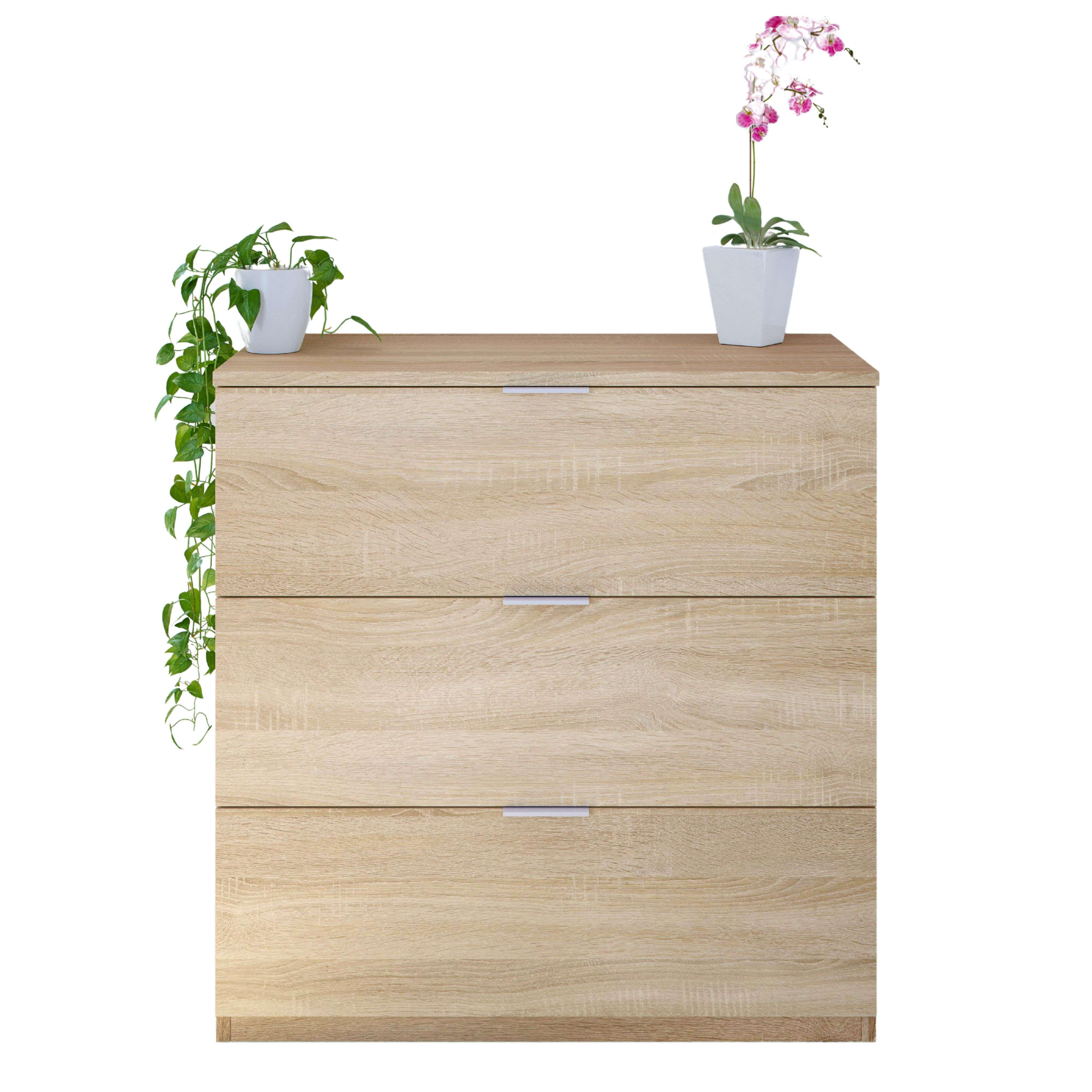 Cómoda de madera con tres cajones y dos plantas en maceta.