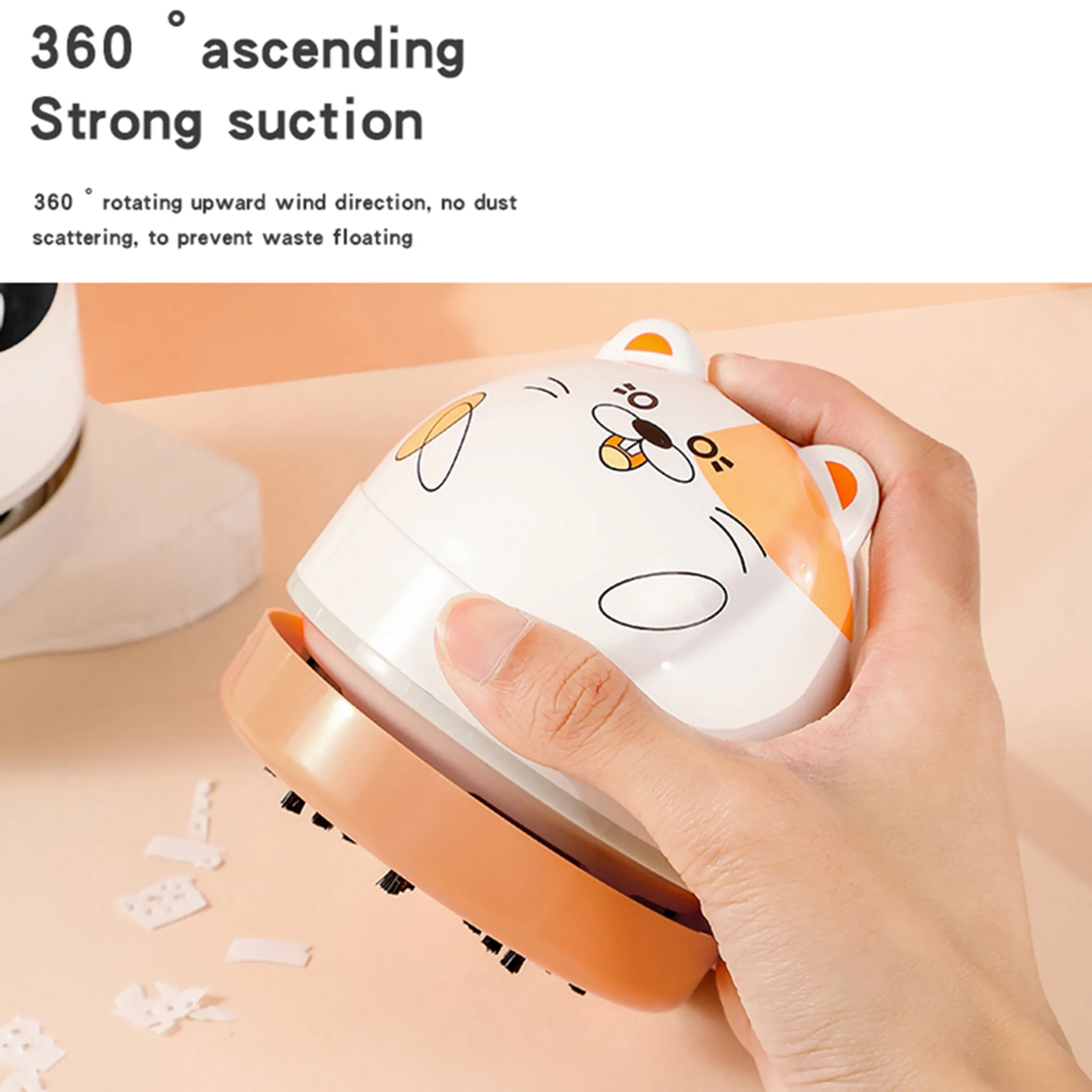 Hand hält einen niedlichen weißen und orangen Desktop-Staubsauger im Katzen-Design.