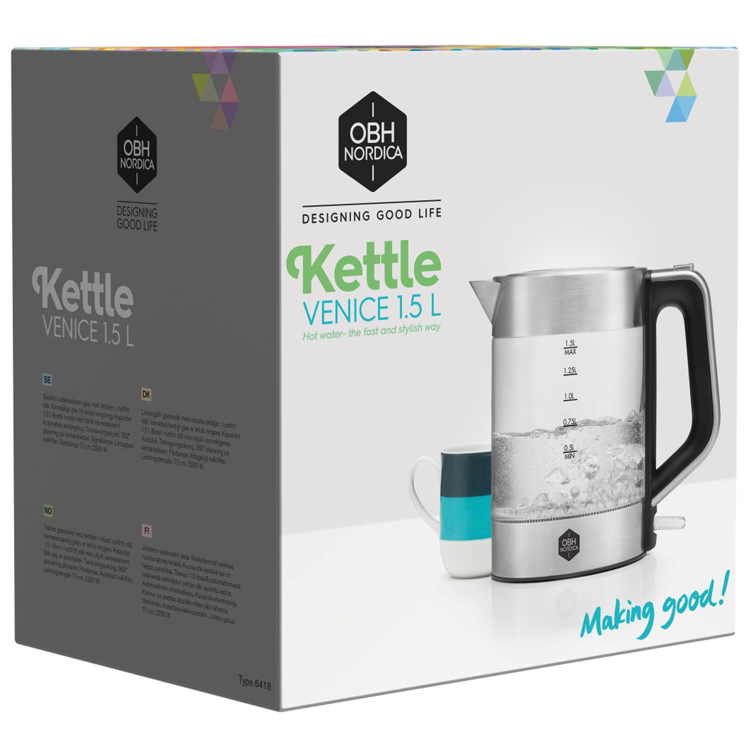 A silver glass kettle with a black handle sits beside a mug.