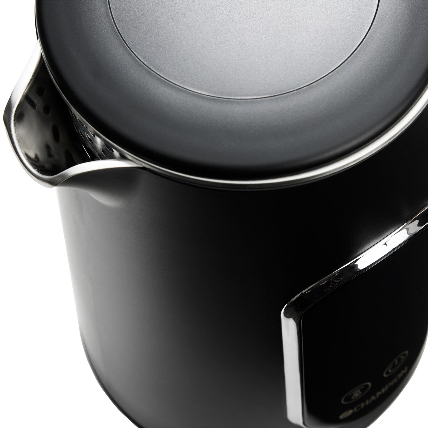 Close-up of a black kettle with silver accents and a perforated spout.