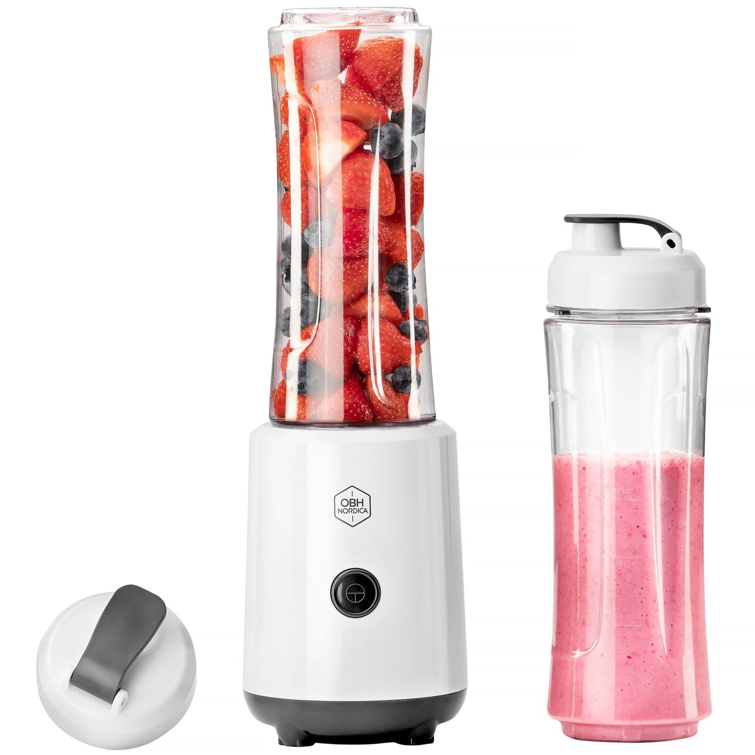 A white blender with berries, a glass of smoothie, and a lid.