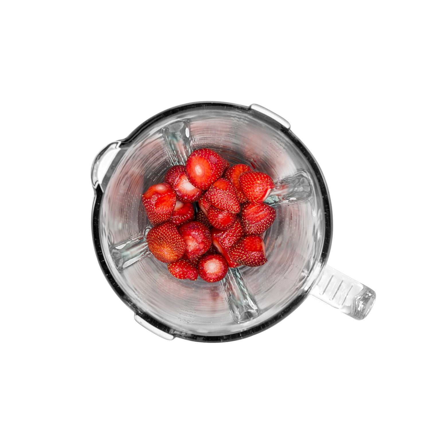 A blender jar filled with sliced strawberries, viewed from above.