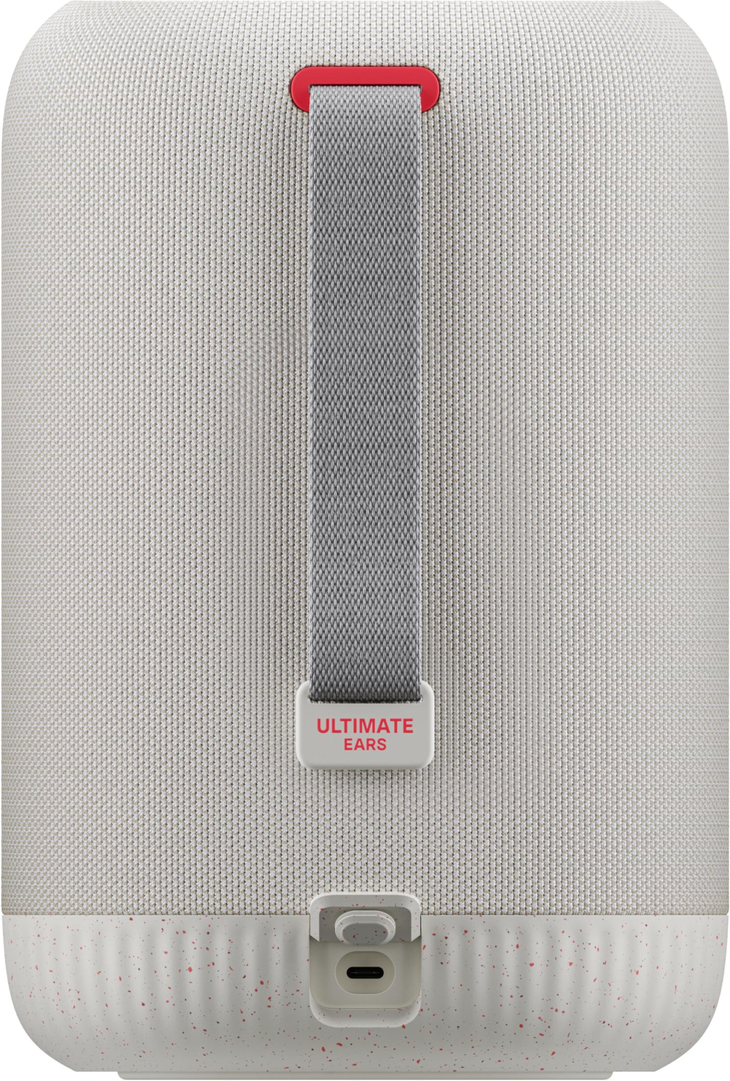 Beżowy głośnik z czerwoną taśmą i logo "ULTIMATE EARS".