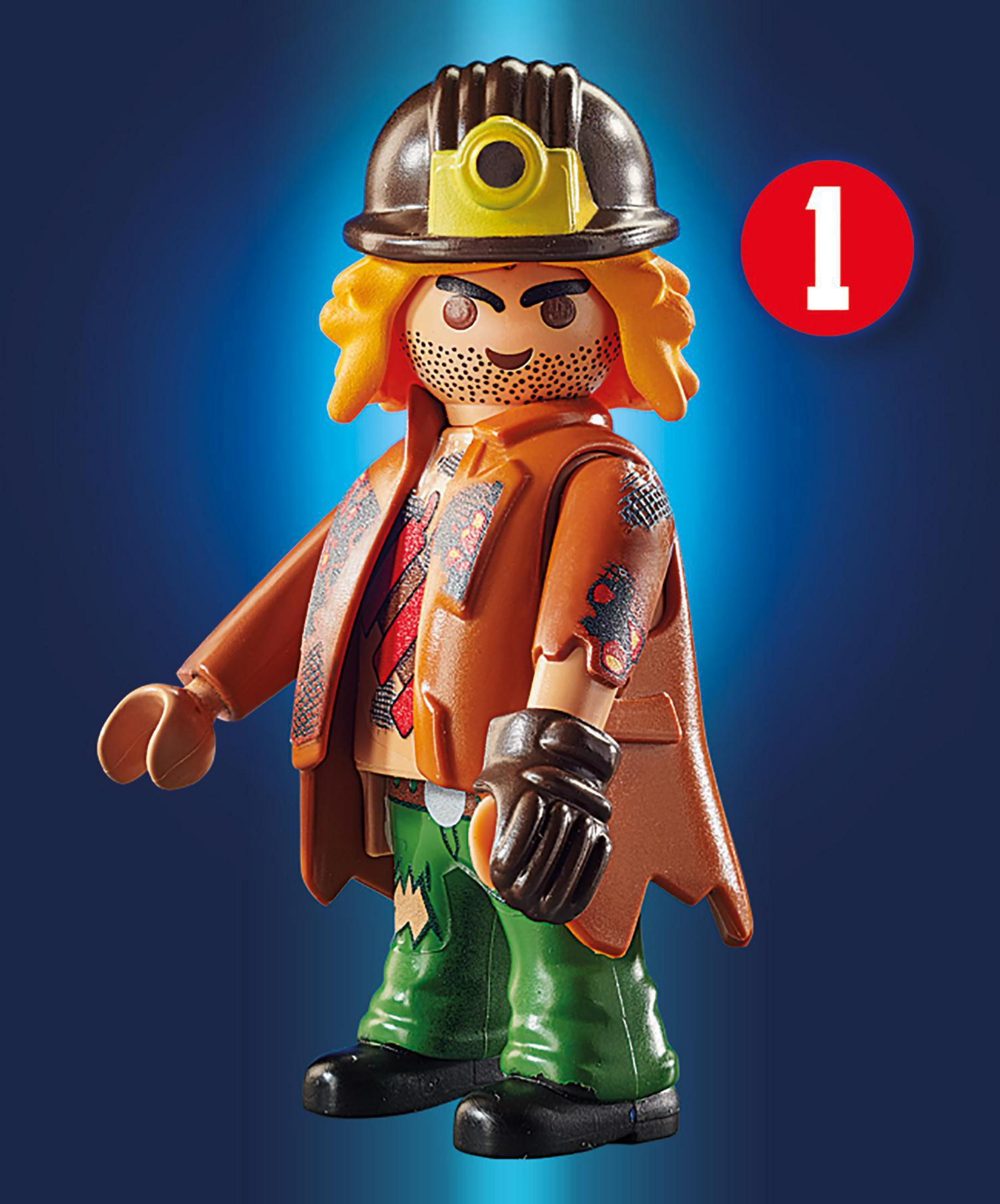 Figurka z brązowym kaskiem, pomarańczową kurtką, zieloną koszulą i spodniami.