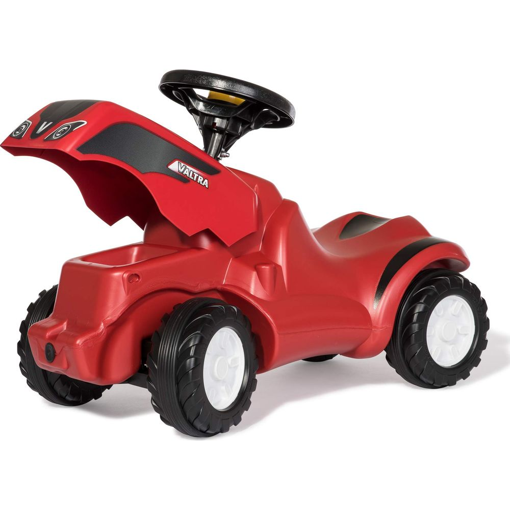 Ein rotes Spielzeugtraktor mit schwarzem Lenkrad und Aufklebern.