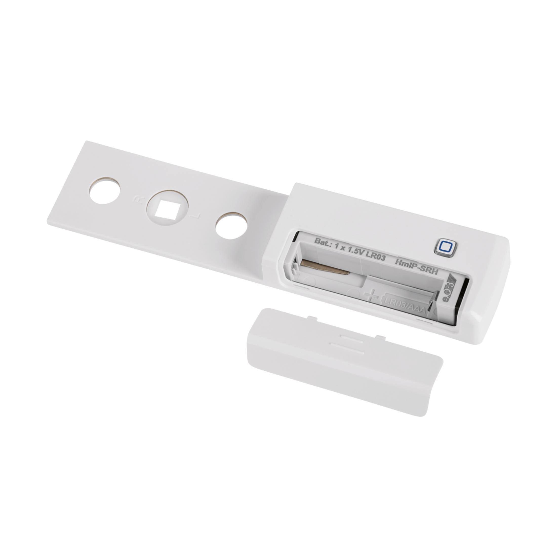 Białe urządzenie z komorą na baterie i zdjętą pokrywą.