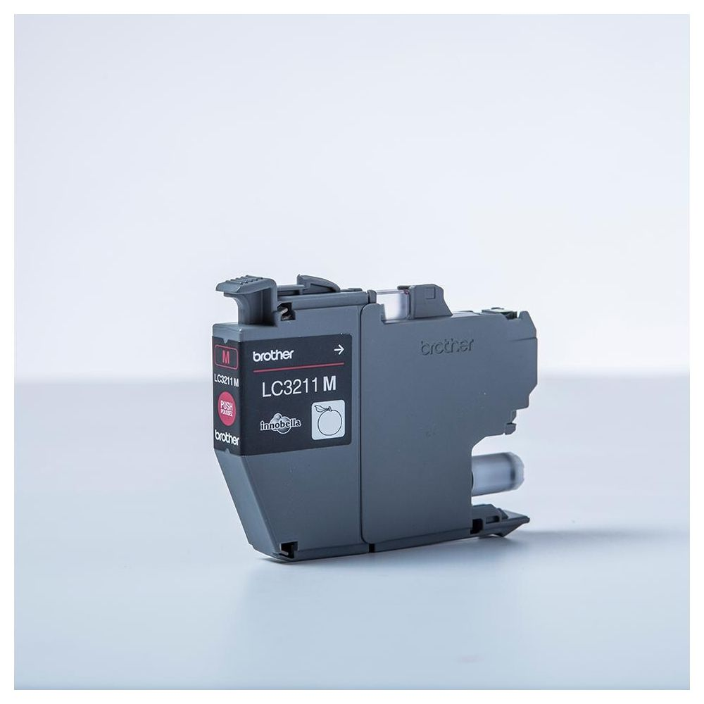 Szara wkładowka atramentowa Brother LC3211M z etykietą i przyciskiem.