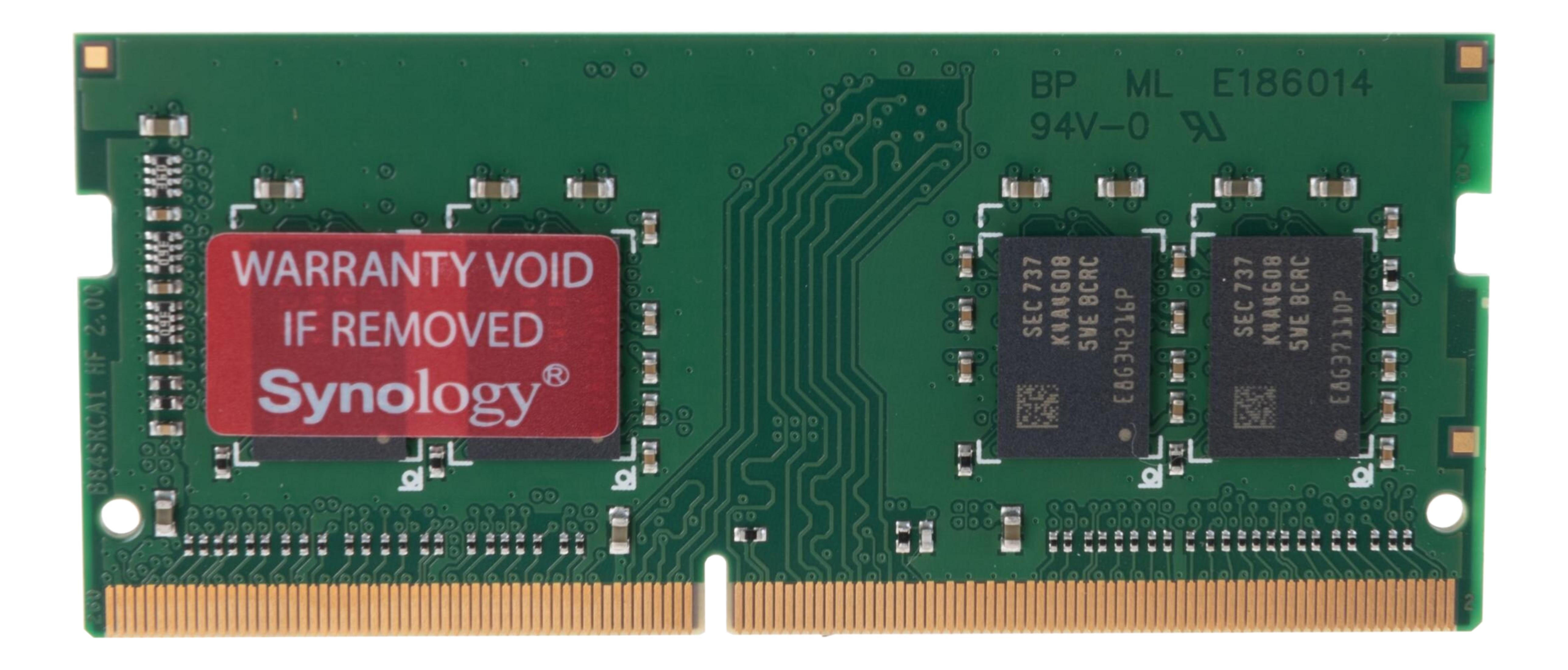 Zielona płyta z złotymi stykami, dwoma czarnymi chipami i czerwoną naklejką gwarancyjną.