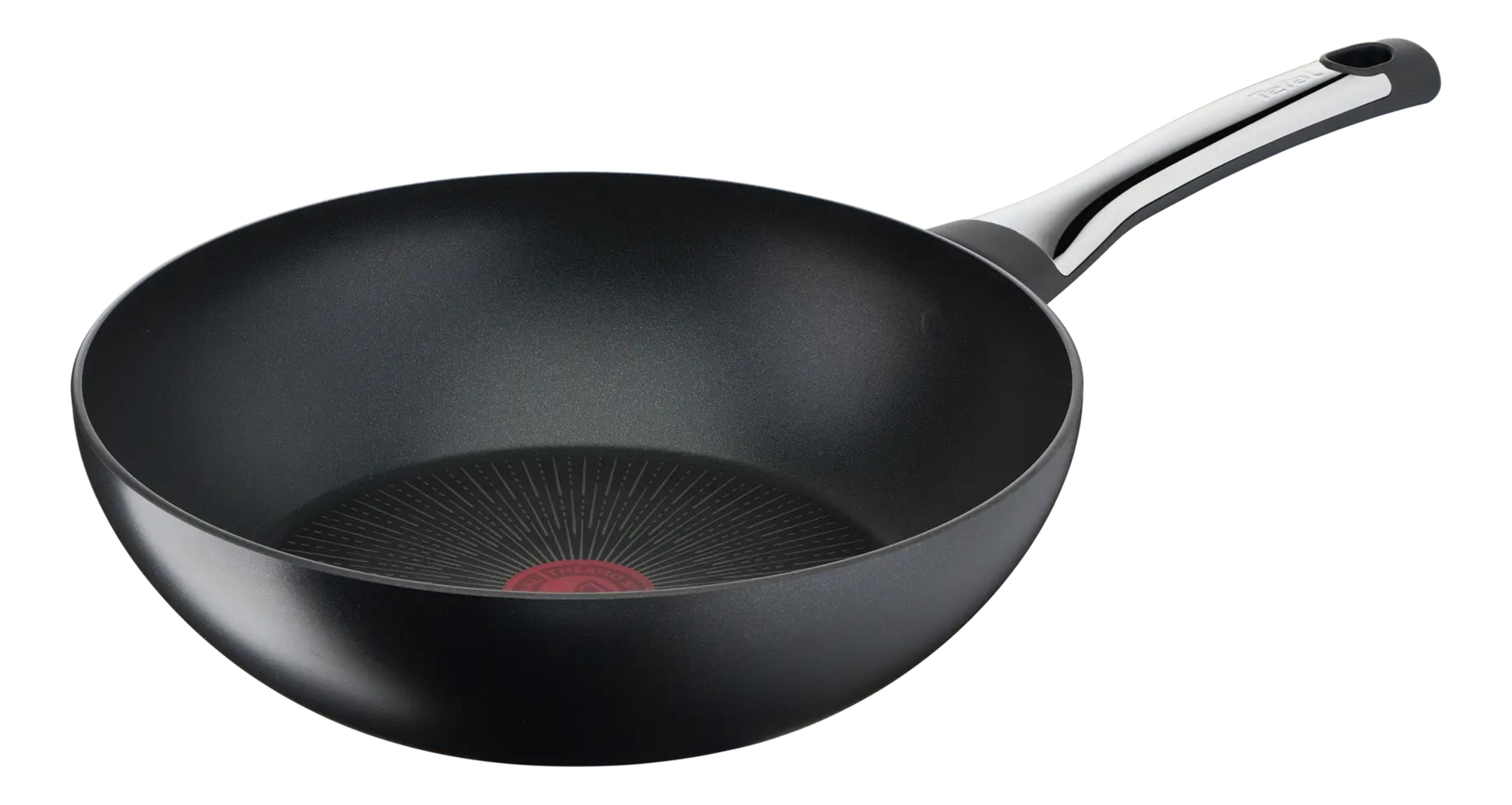 Czarna patelnia wok z długą, srebrną rączką i czerwonym wskaźnikiem ciepła.