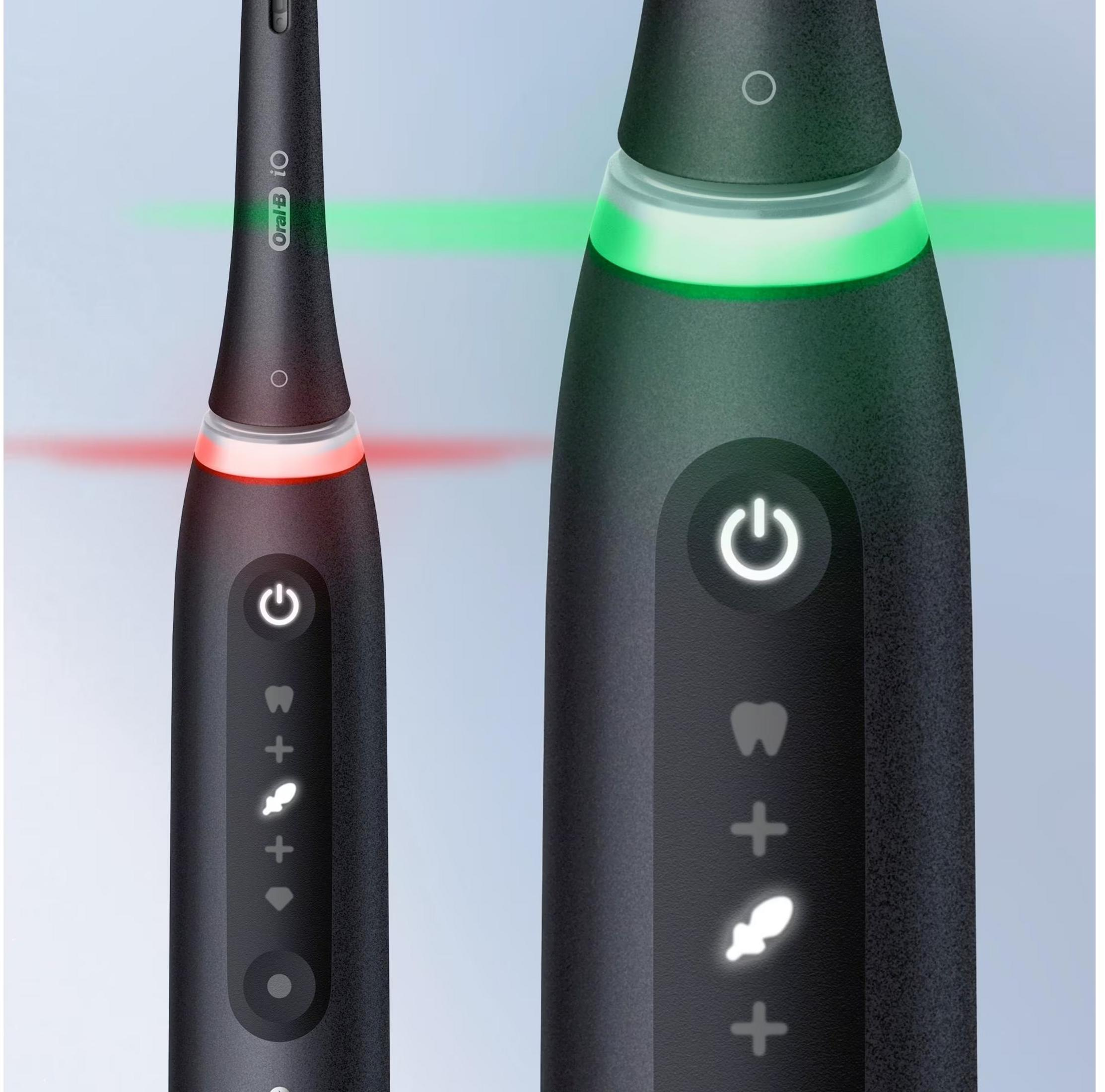 Czarna szczoteczka elektryczna z czerwonym i zielonym pierścieniem świetlnym, przyciskiem zasilania i ikonami.