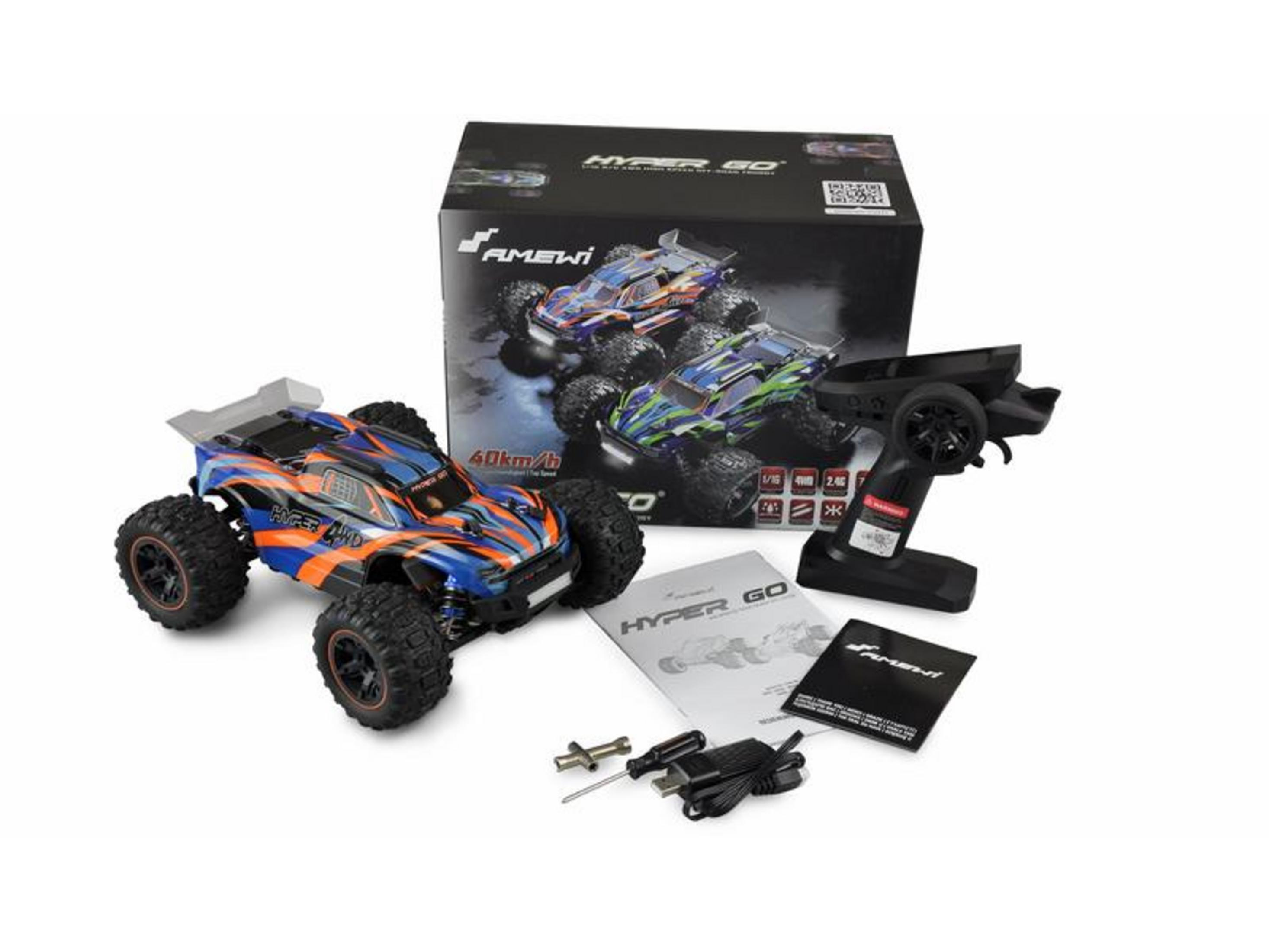 Un monster truck azul y naranja a control remoto con control negro, manual y cable de carga.