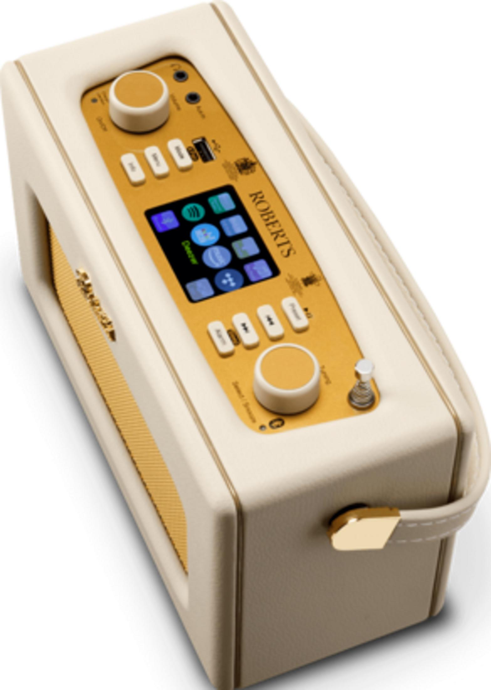 Kremowe radio Roberts ze złotymi przyciskami i ekranem.