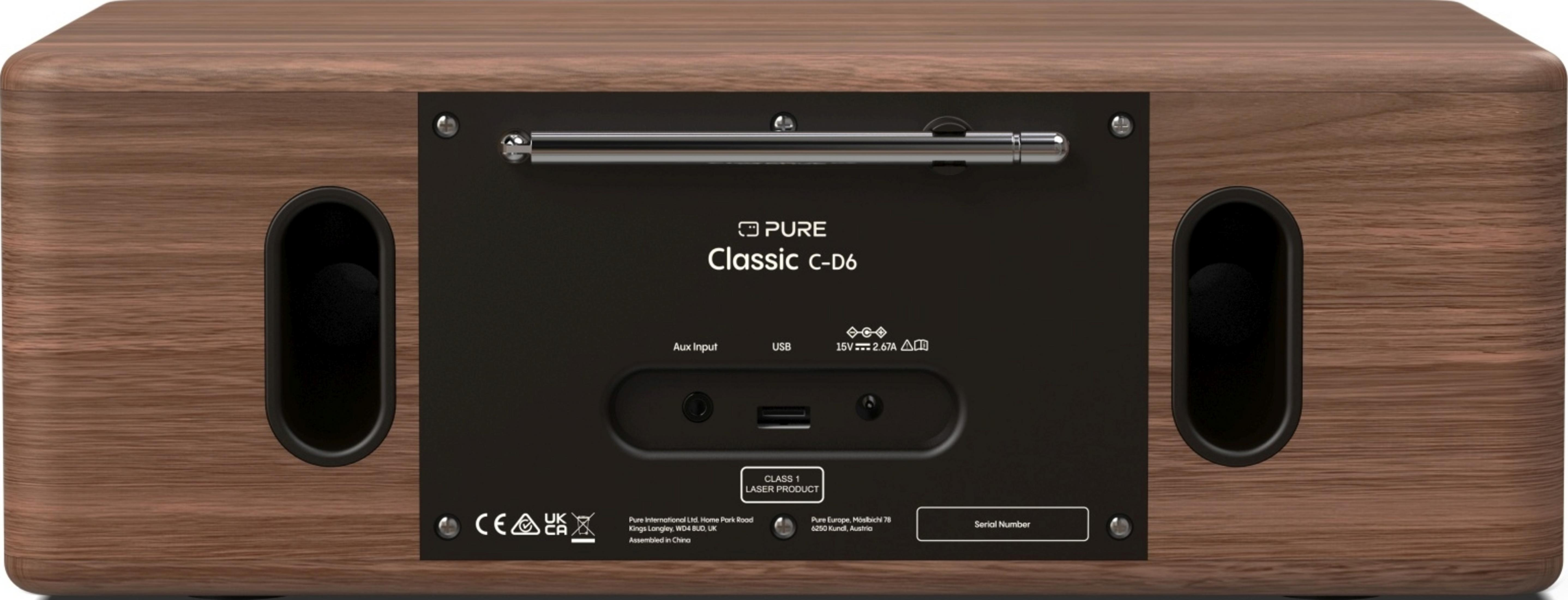 Tył drewnianego radia z portami, anteną i etykietami.